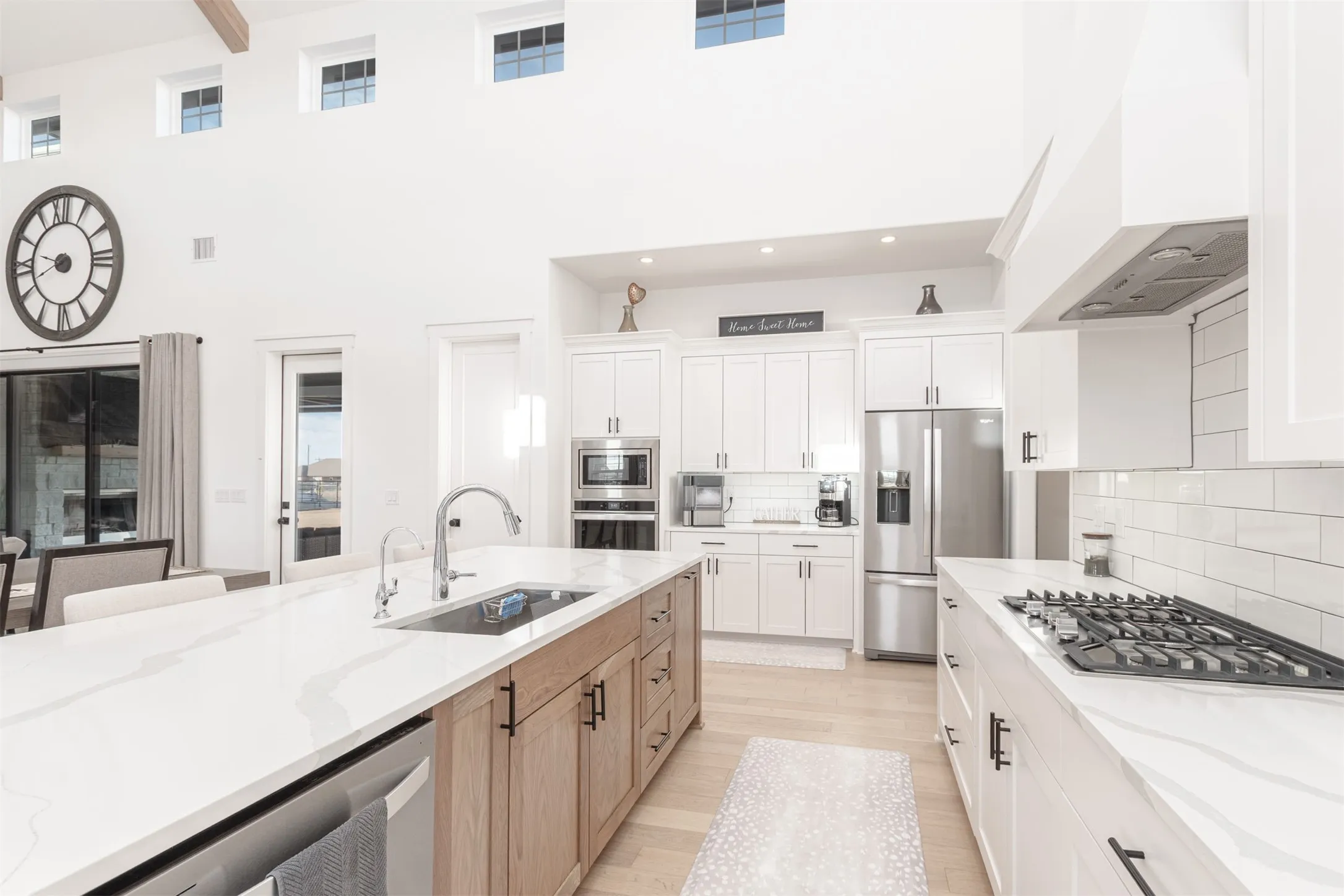 Oversized Kitchen Island with 5 burner cooktop, Refrigerator, Microwave and Oven. There is an abundance of kitchen counter space and cabinets
