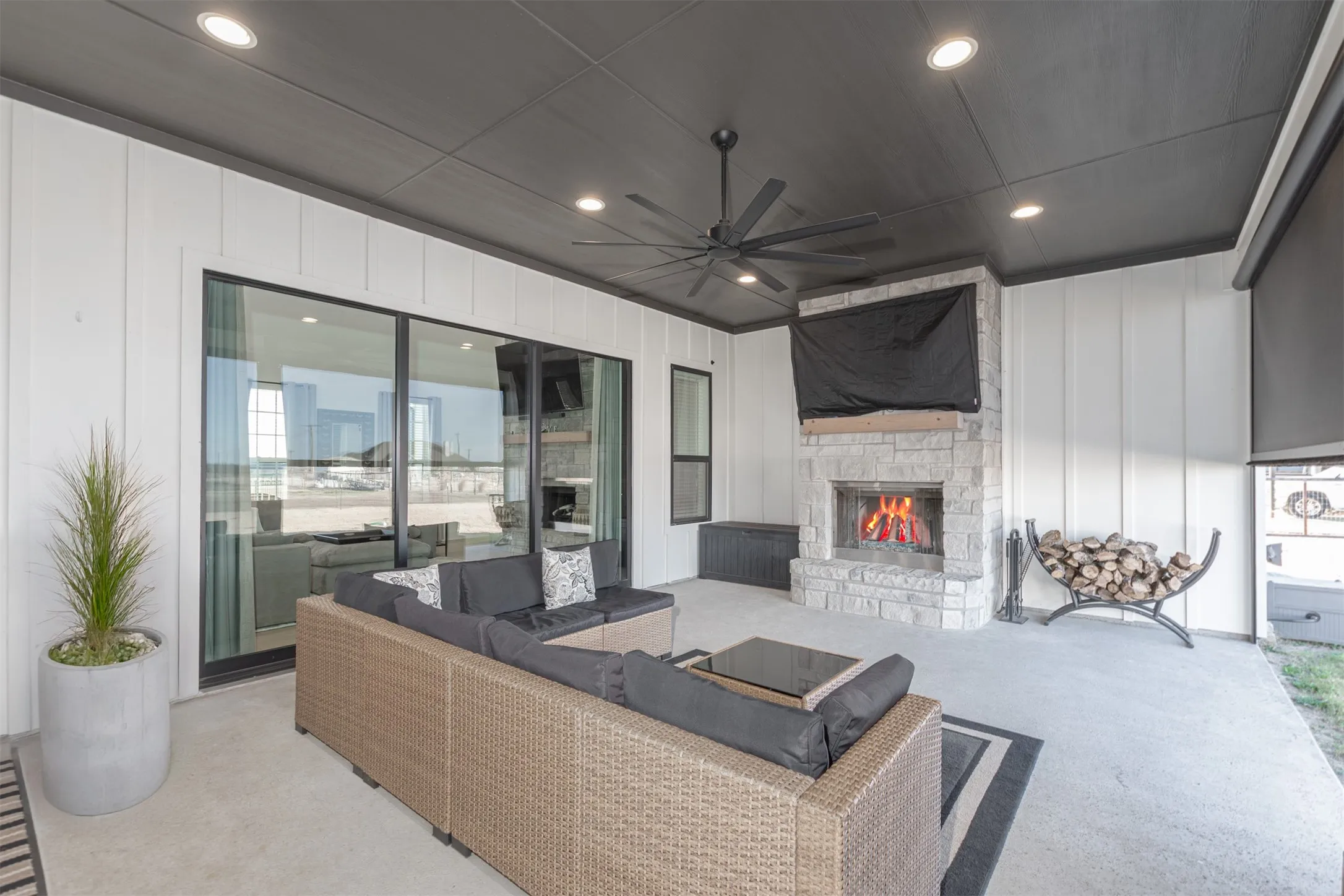 Covered Patio with Outdoor Gas Fireplace and Remote Controlled Roller Screens