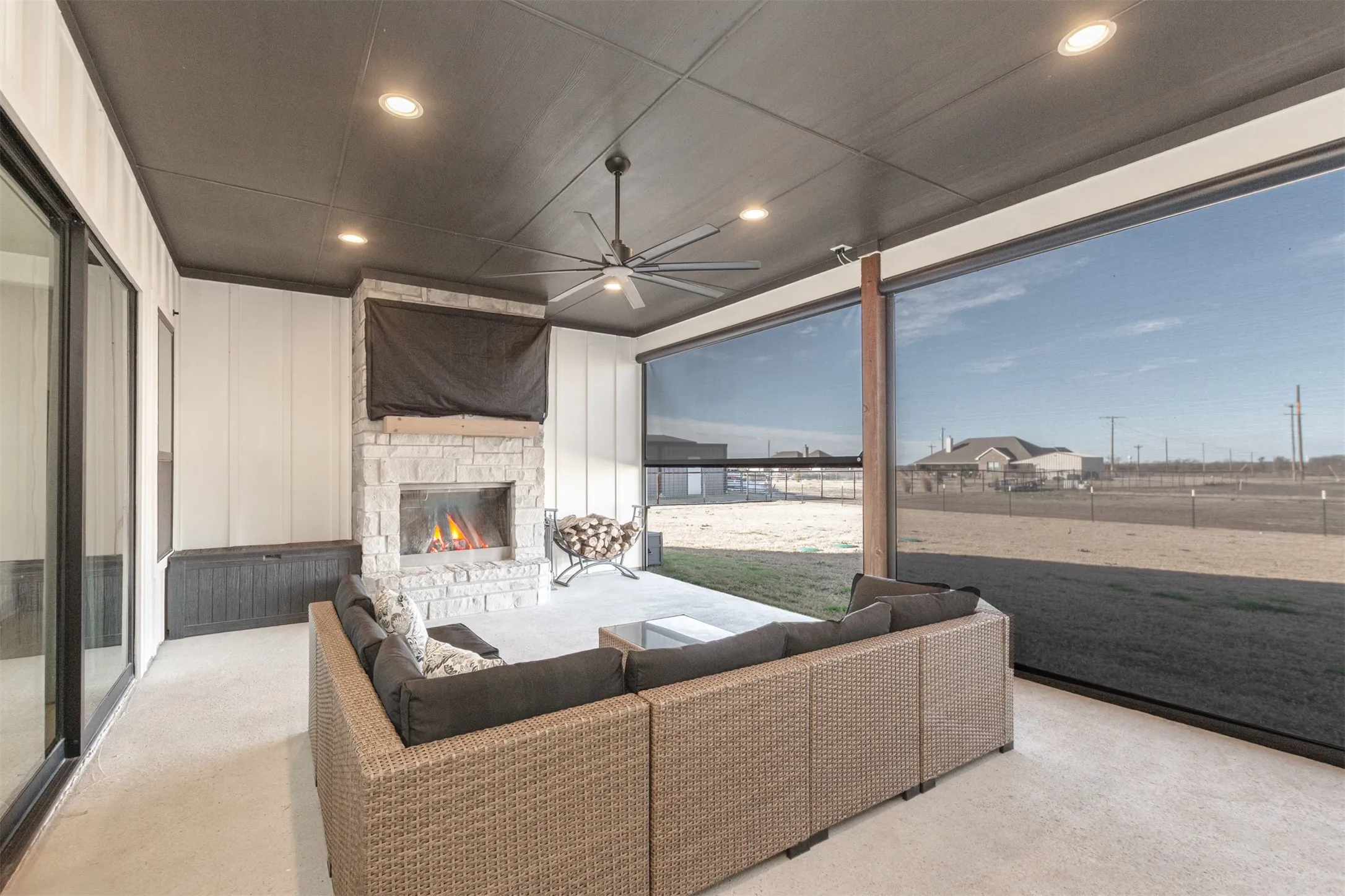 Covered Patio with Outdoor Gas Fireplace and Remote Controlled Roller Screens