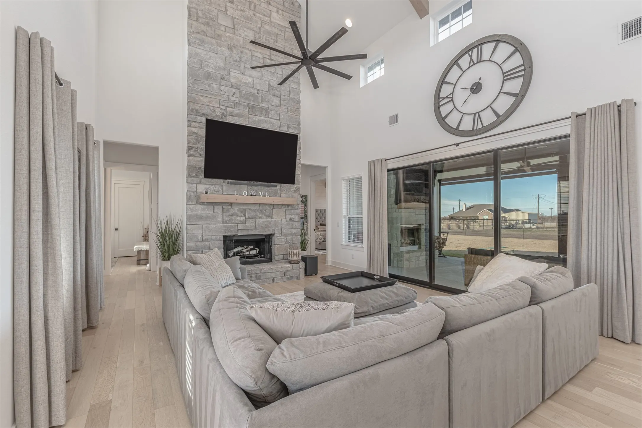 Open Concept and Slider Doors to covered patio with automatic privacy screens and outdoor stone fireplace