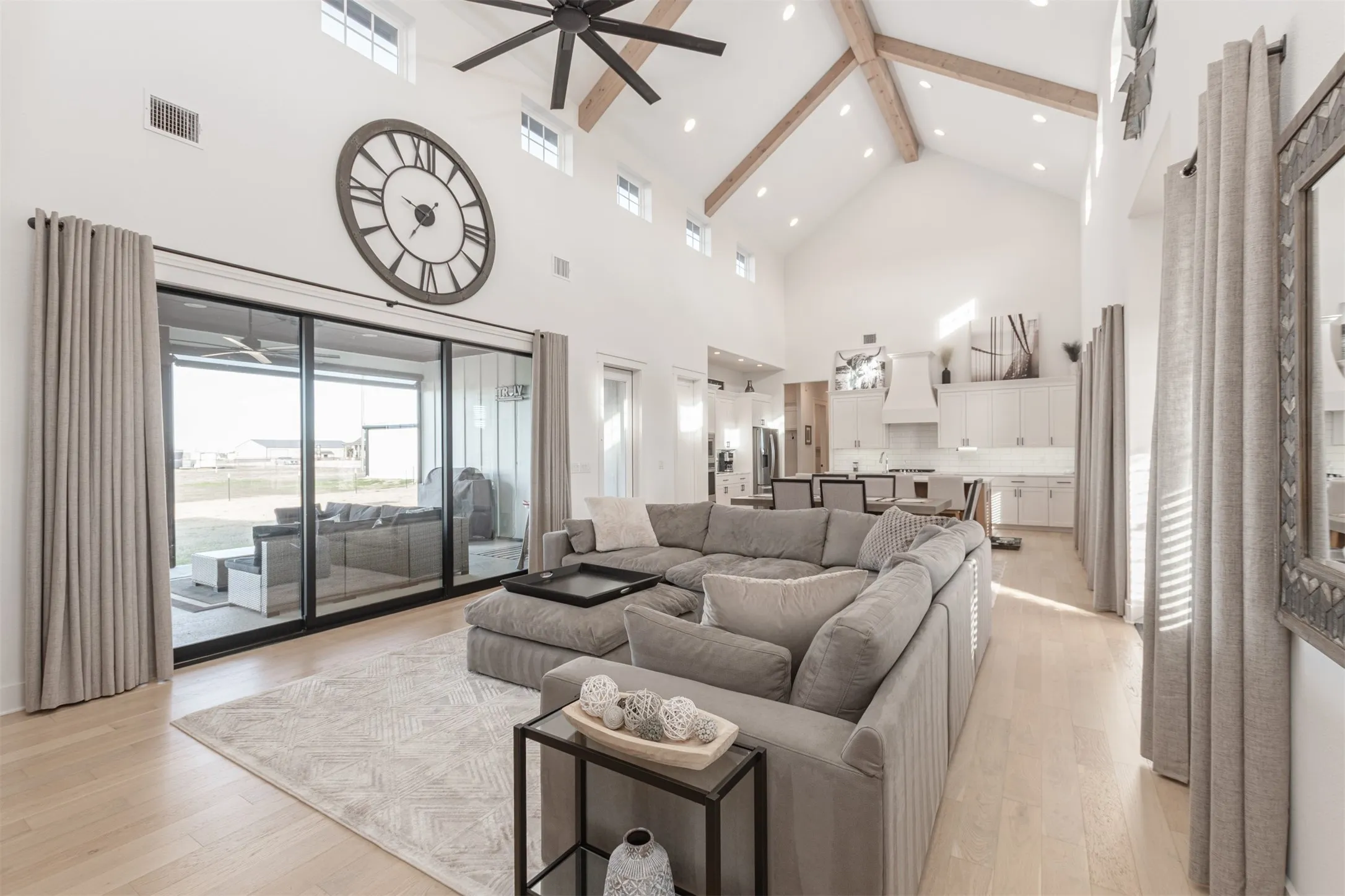 Open Concept and Slider Doors to covered patio with automatic privacy screens and outdoor stone fireplace