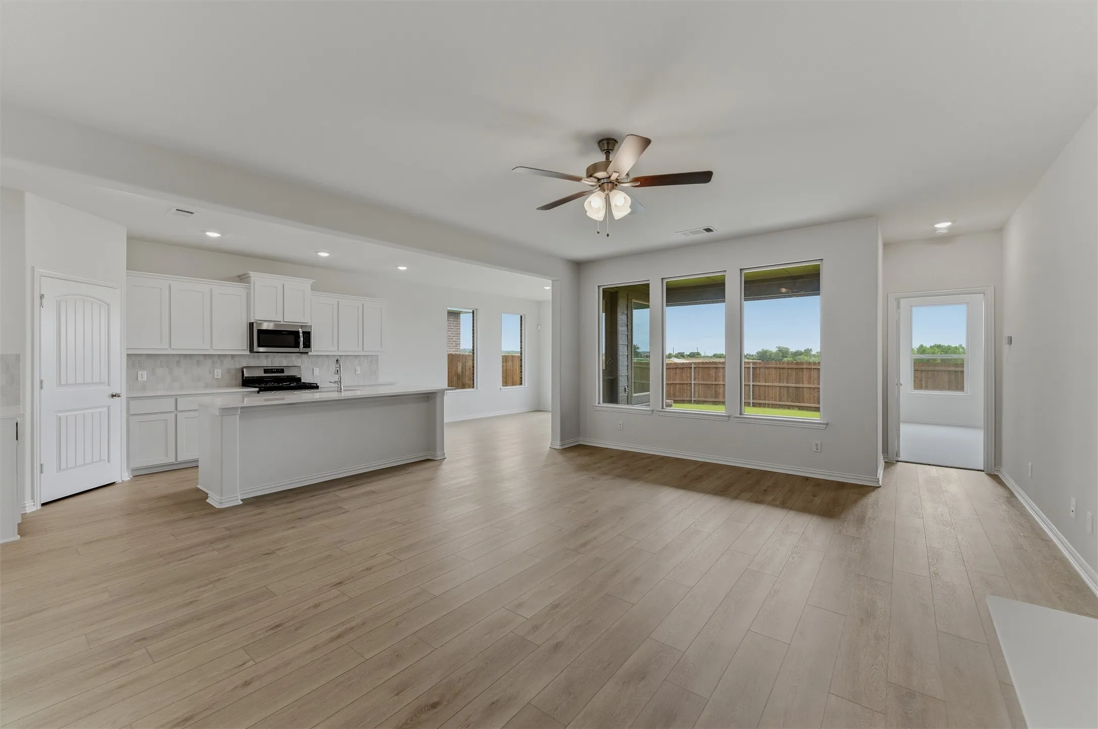 Open concept living area with wood-finish flooring throughout
