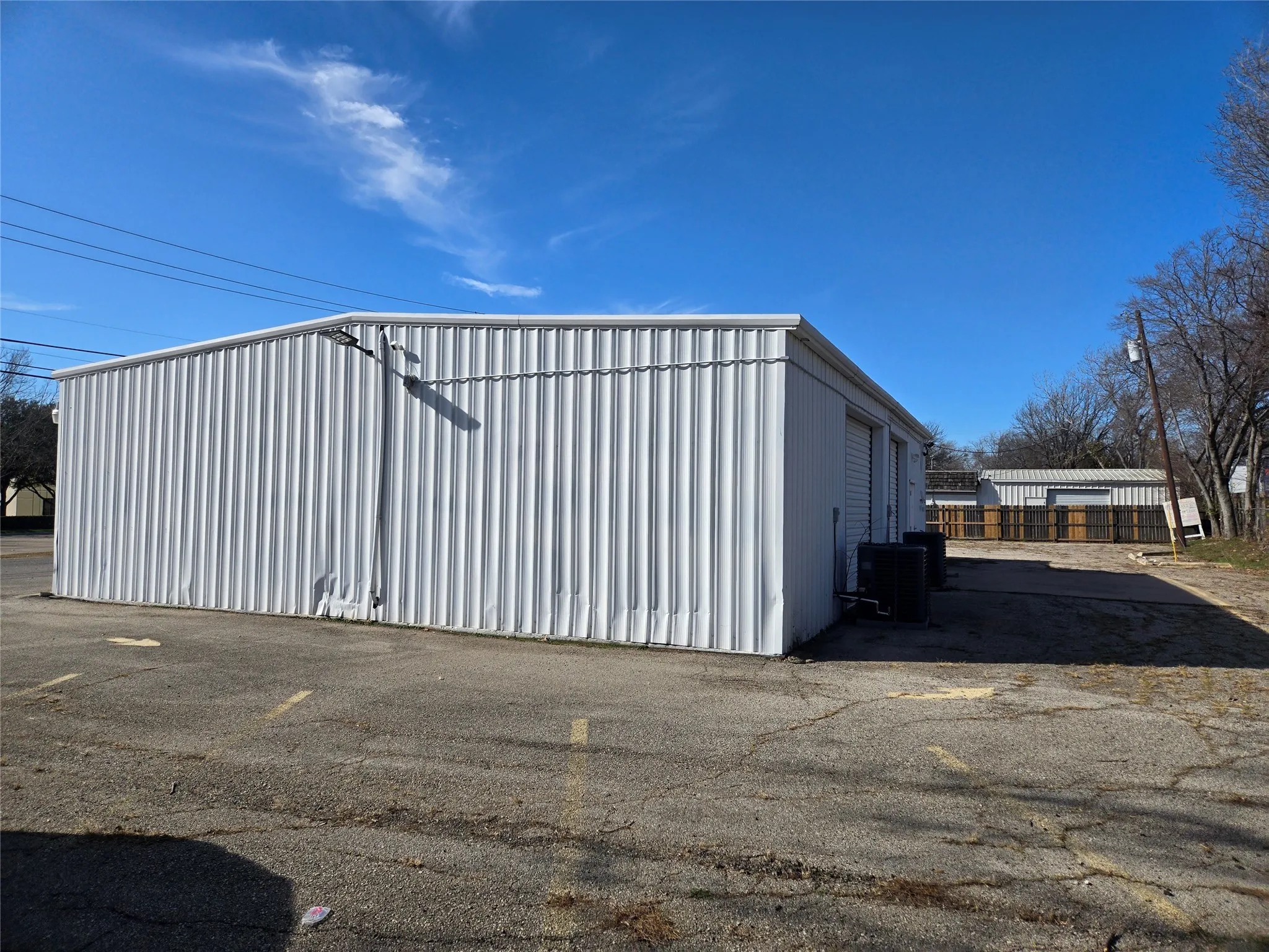 View of property exterior featuring a cooling unit and an outbuilding