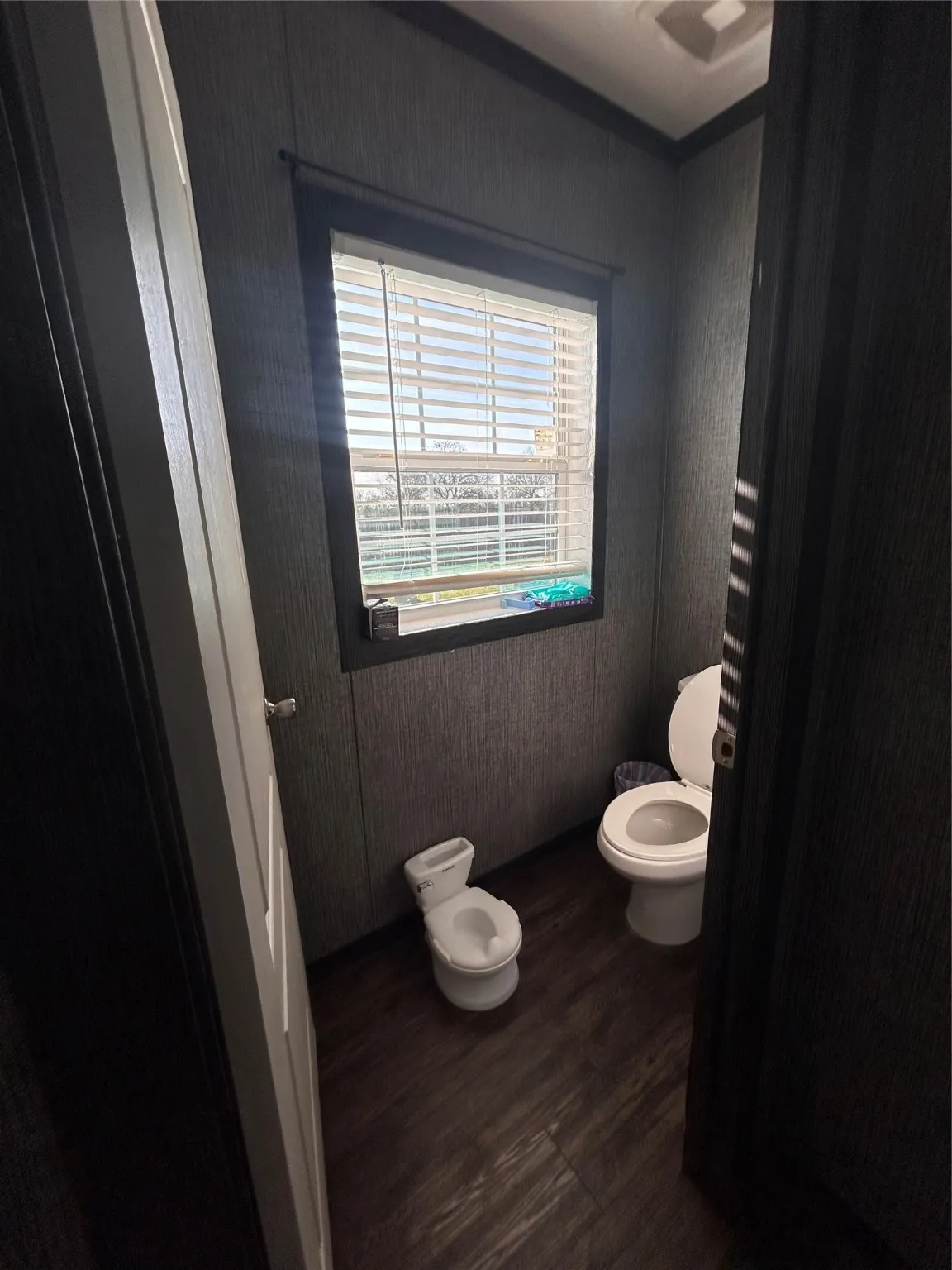 Bathroom with toilet and dark wood-type flooring
