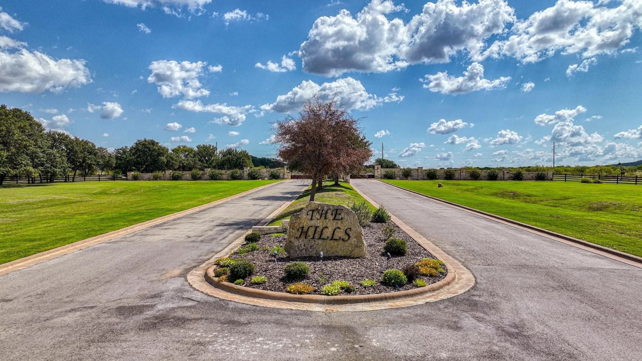 View of asphalt road with curbs and a rural view