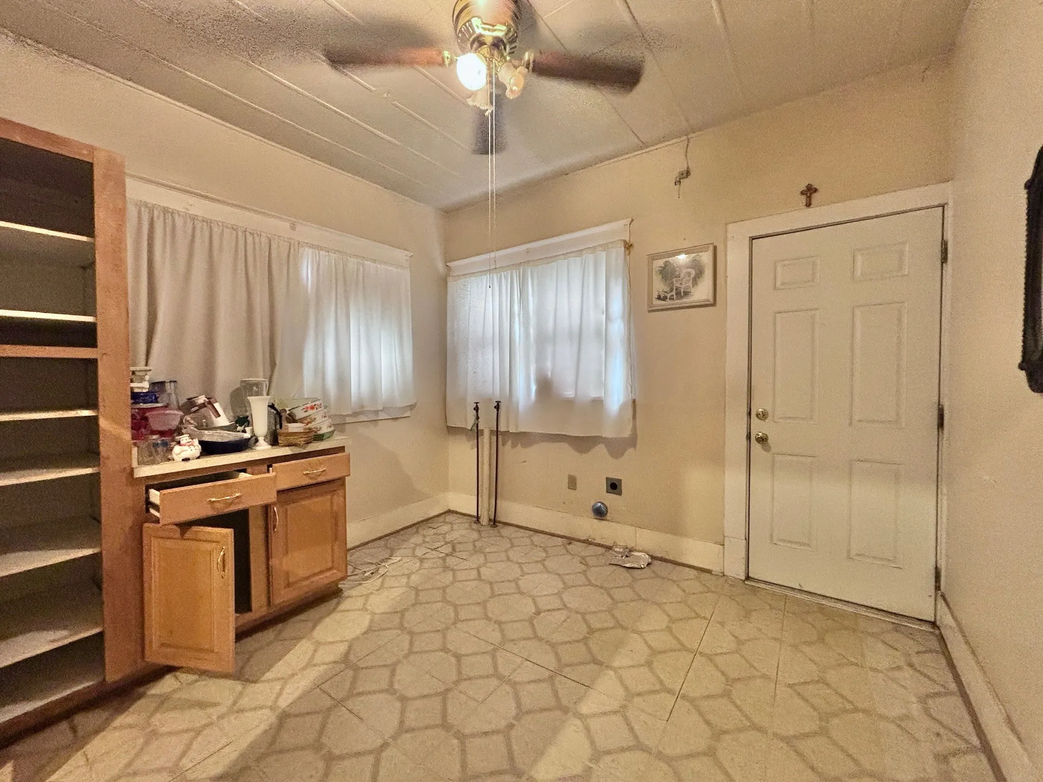 Home office with a ceiling fan and light floors
