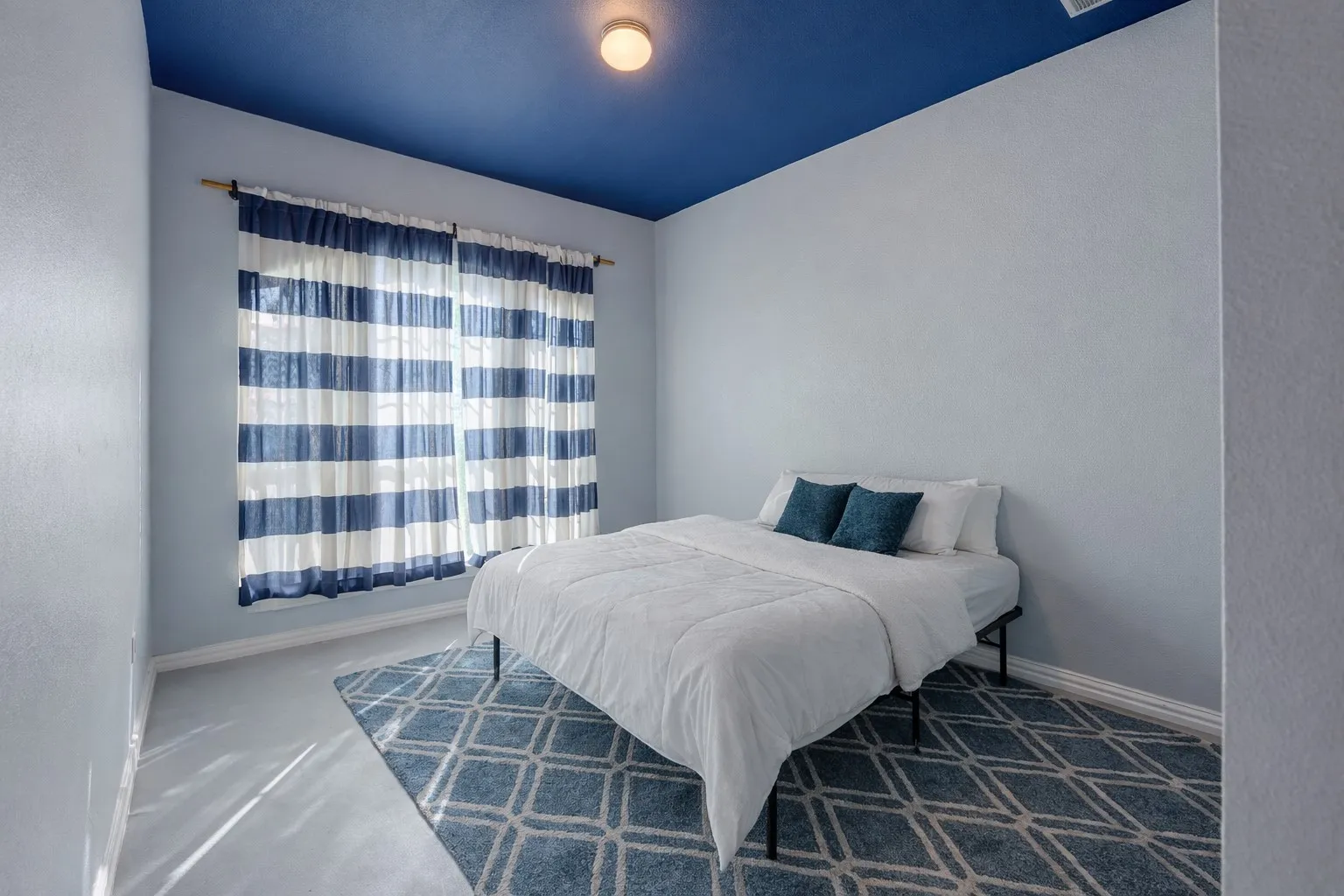 Carpeted bedroom with a textured wall