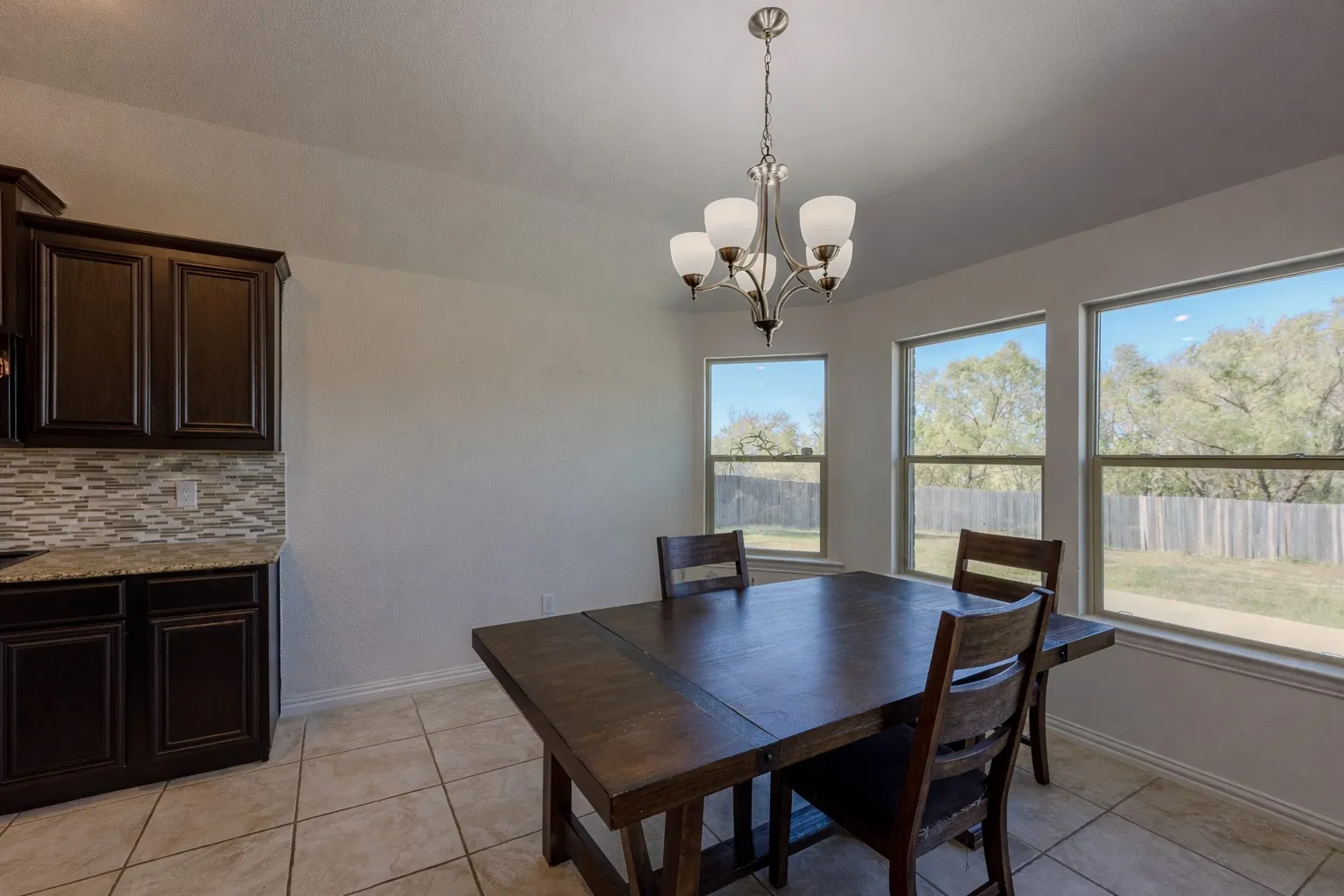 Dining area featuring light tile patterned floors and a chandelier