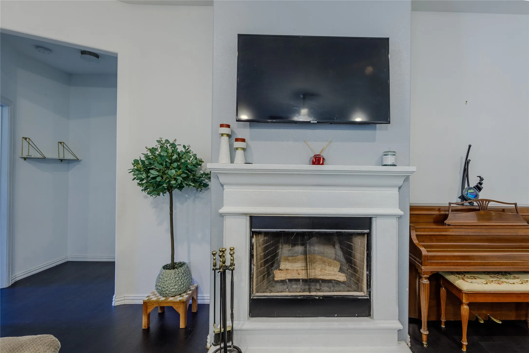 Detailed view of a fireplace and wood finished floors