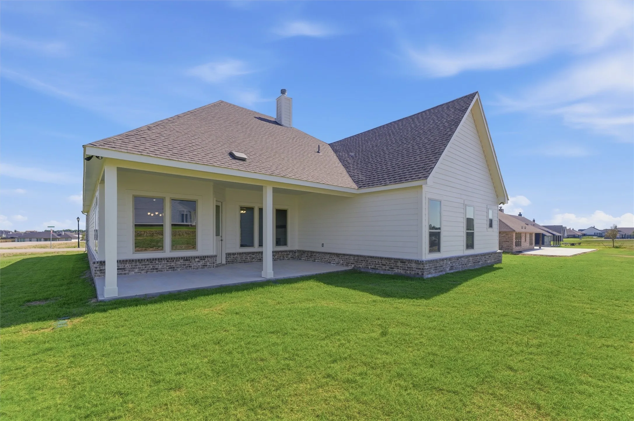 Expansive rear patio with covered outdoor space