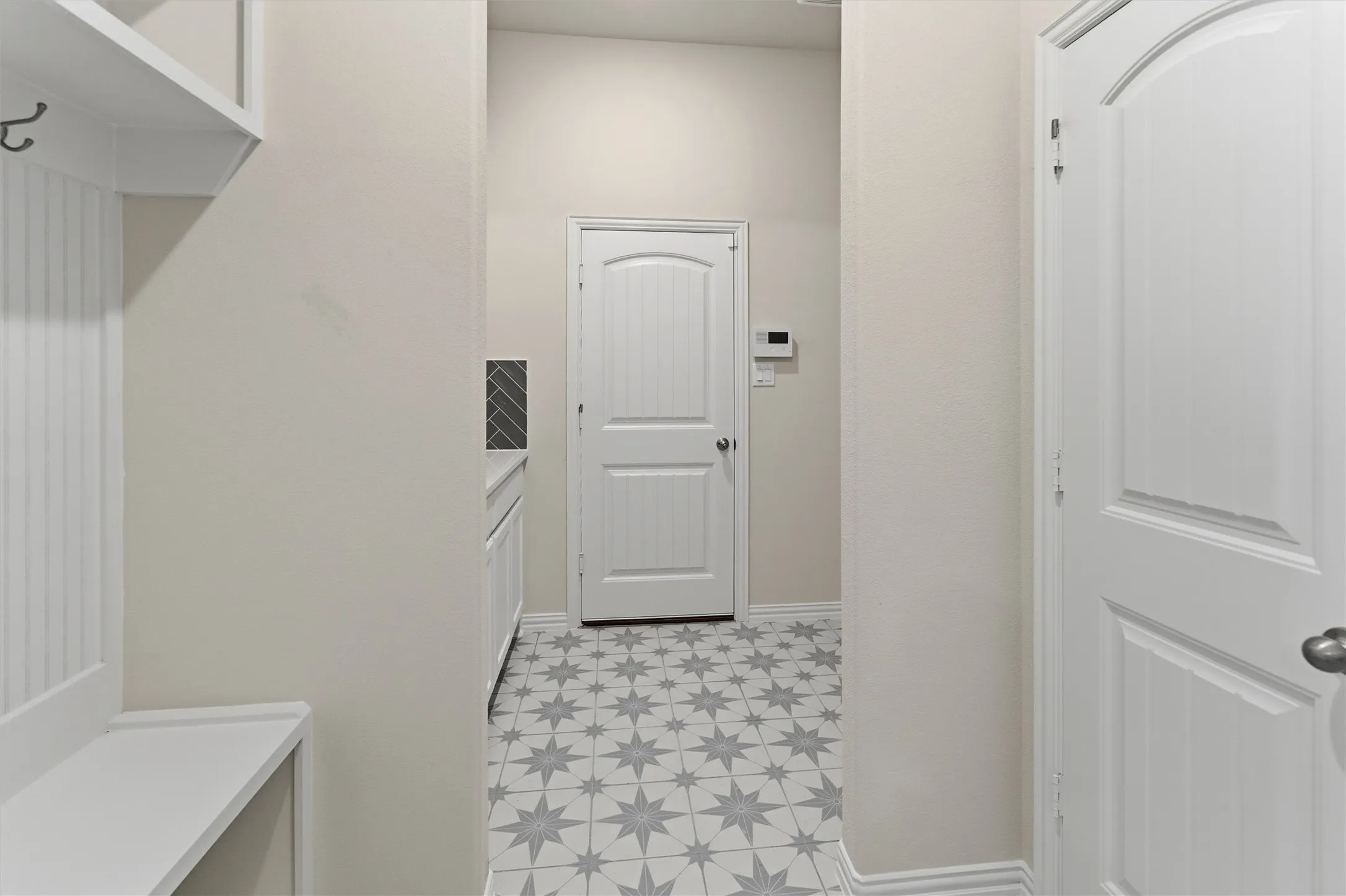 Entryway with star-patterned tile flooring