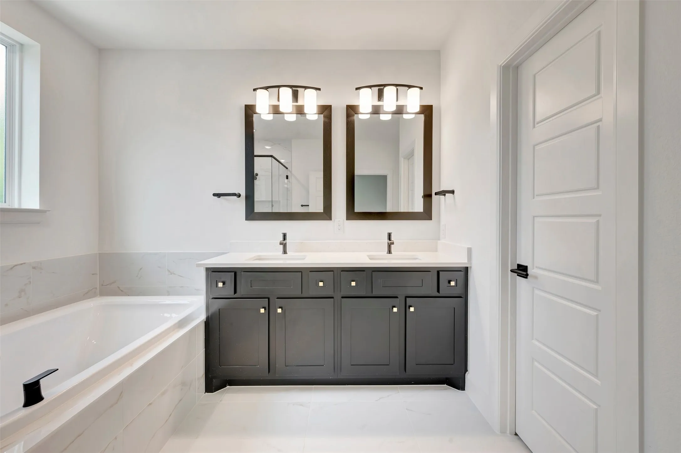 Dual vanity with quartz countertops, undermount sinks, and matte black fixtures