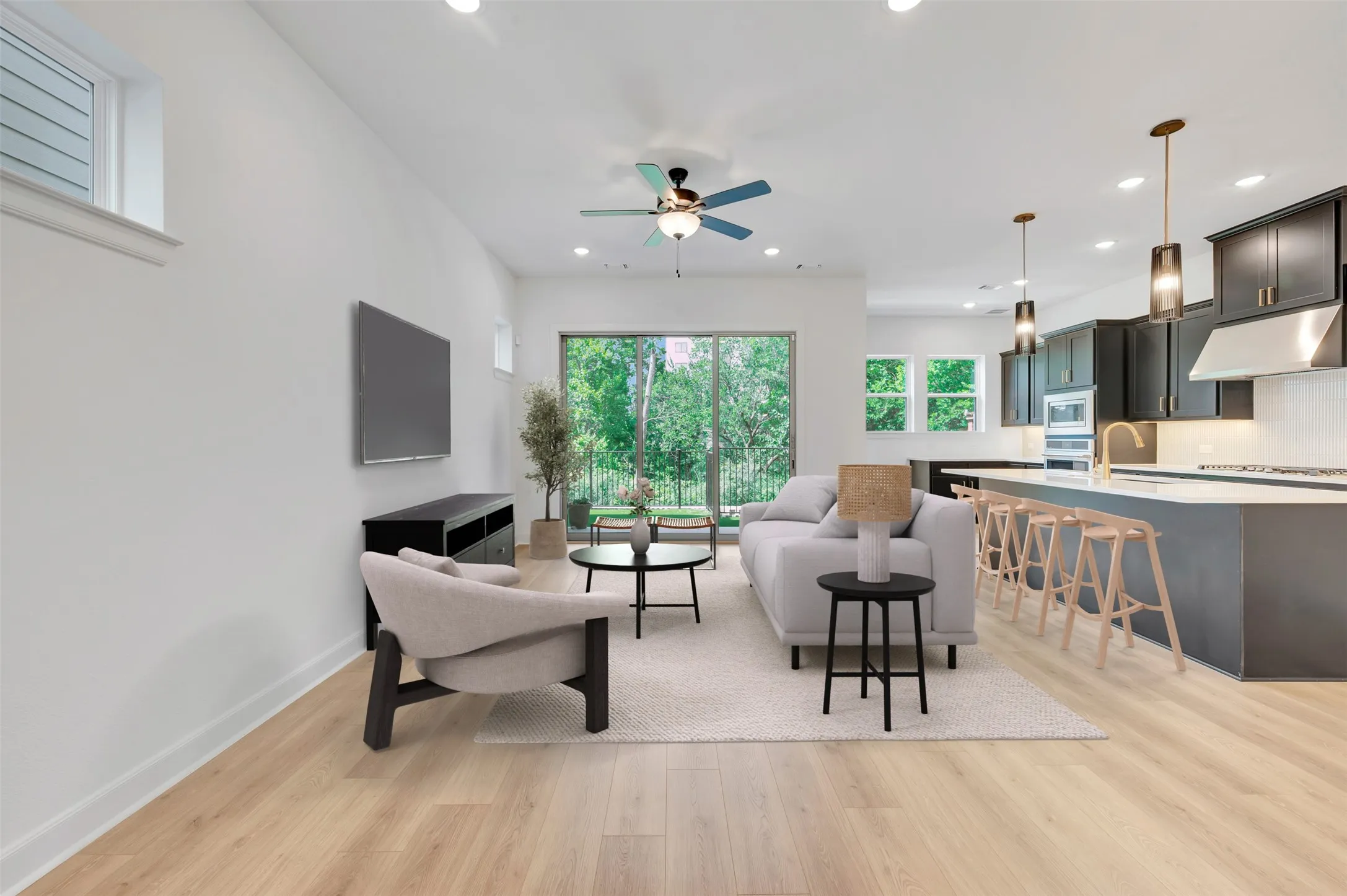 Open-concept living area with light wood-finish flooring