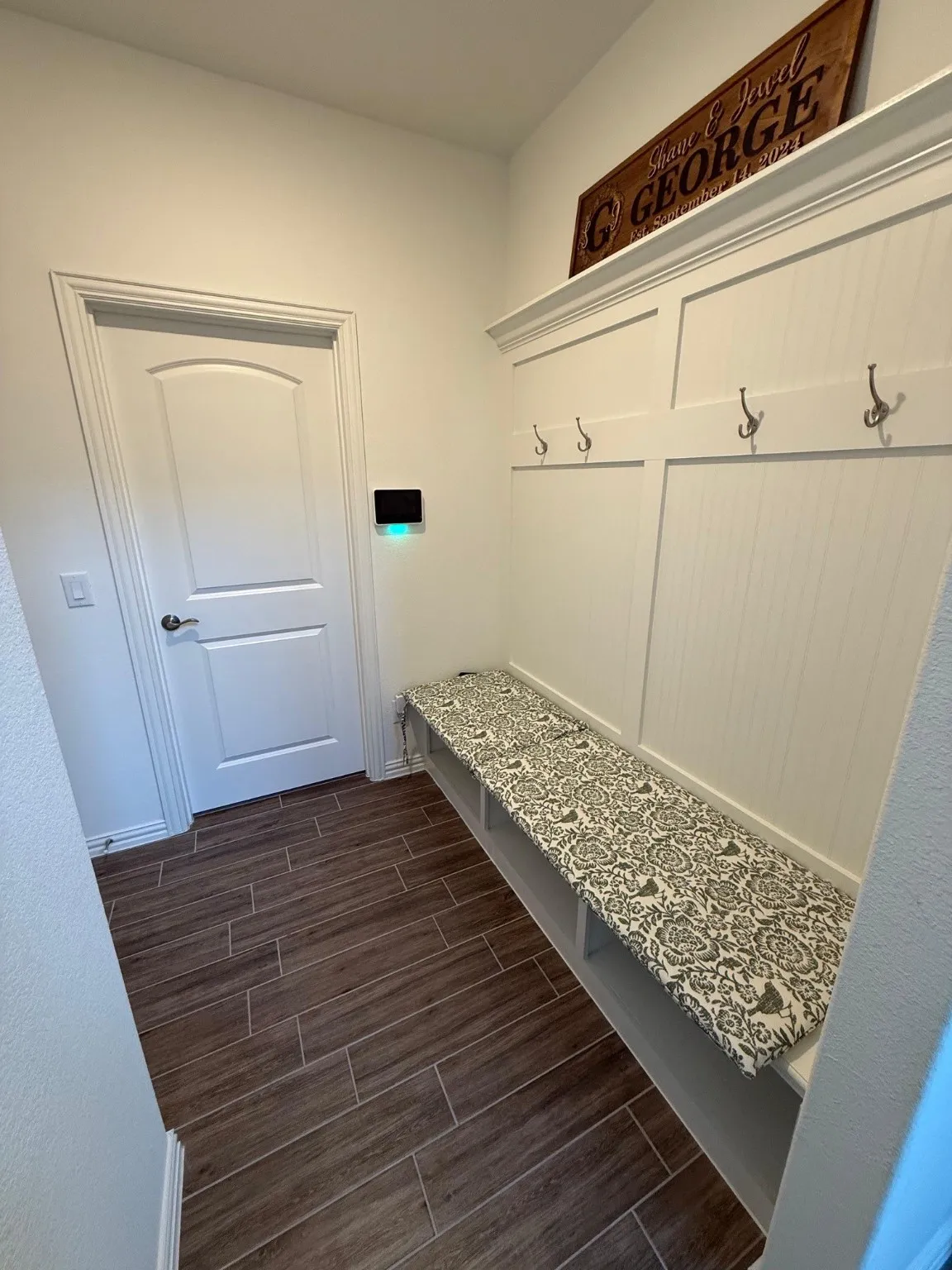 Mudroom featuring wood tiled floors and baseboards