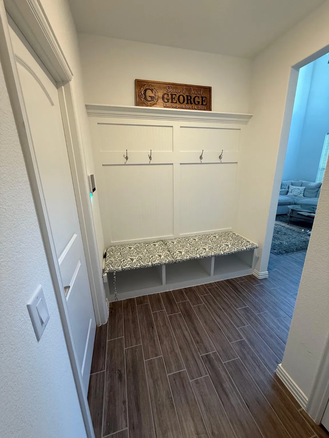 Mudroom featuring wood tiled floors and baseboards