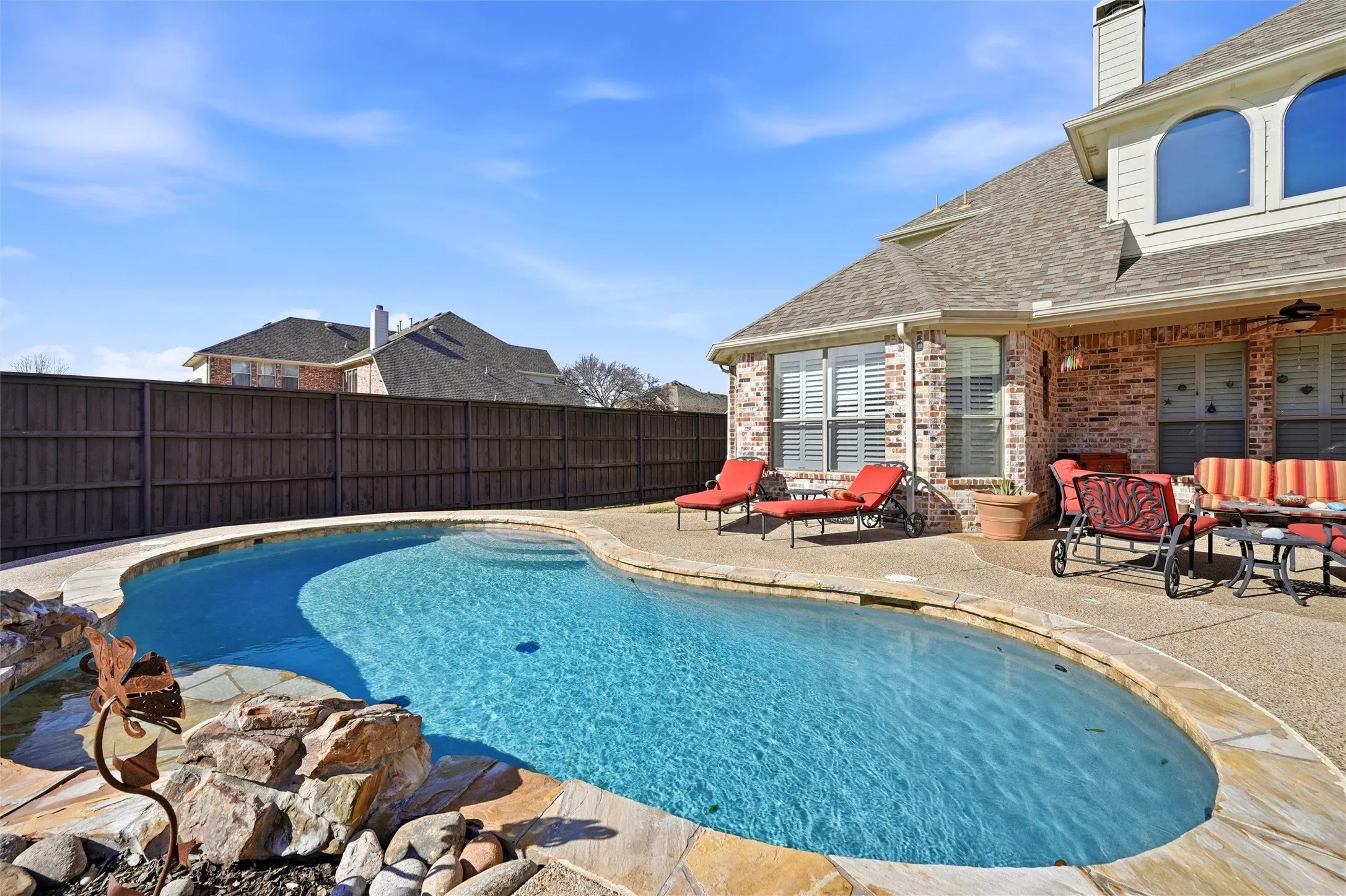 View of swimming pool with a patio area, a fenced backyard, and an outdoor hangout area