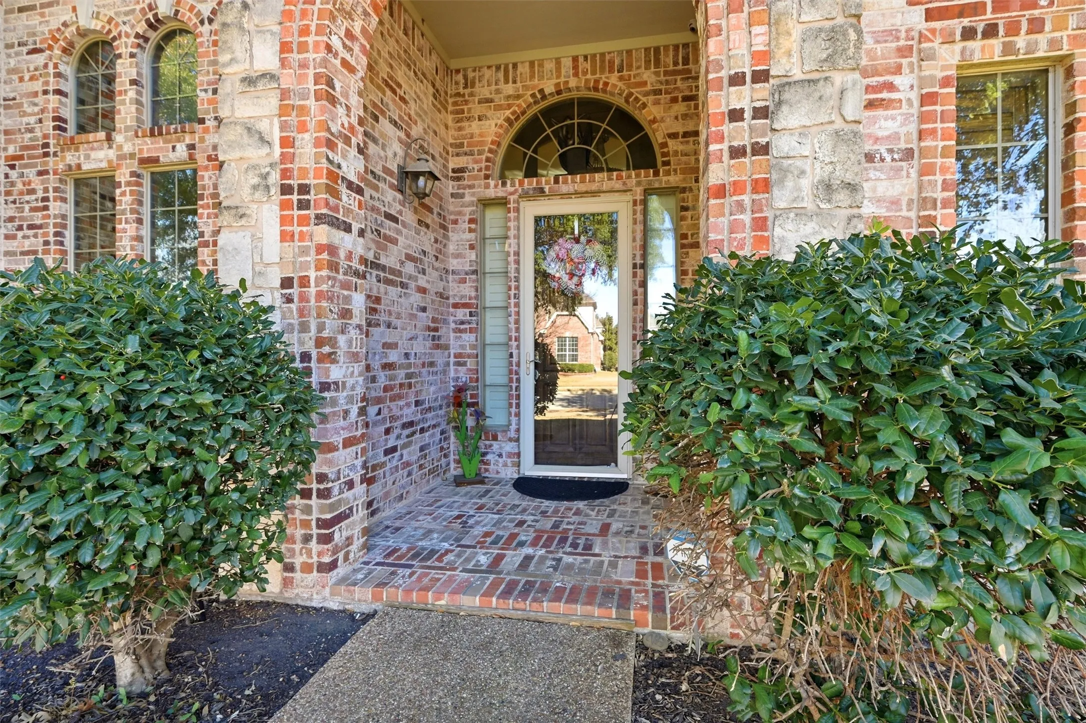 Entrance to property featuring brick siding