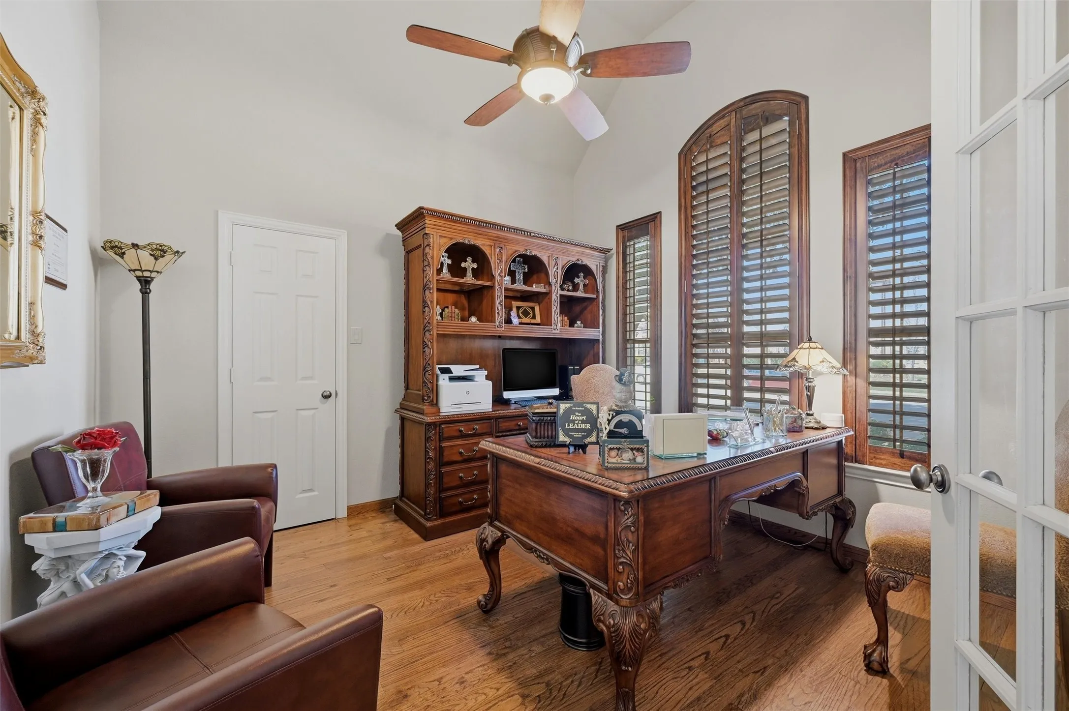 Office space with light wood-type flooring, a ceiling fan, high vaulted ceiling, and french doors