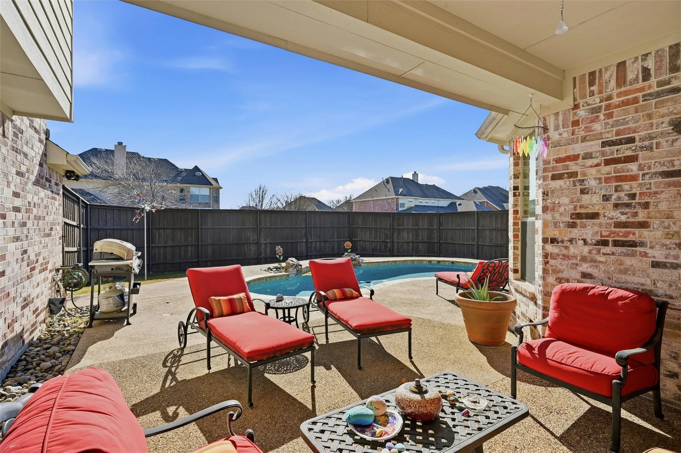 Fenced backyard with a patio and grilling area