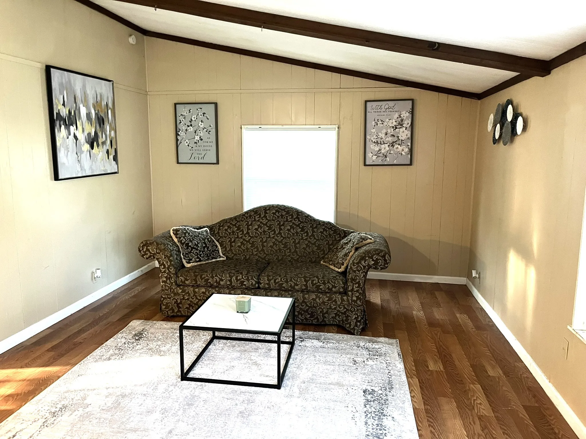 Living room featuring dark wood-style floors and baseboards