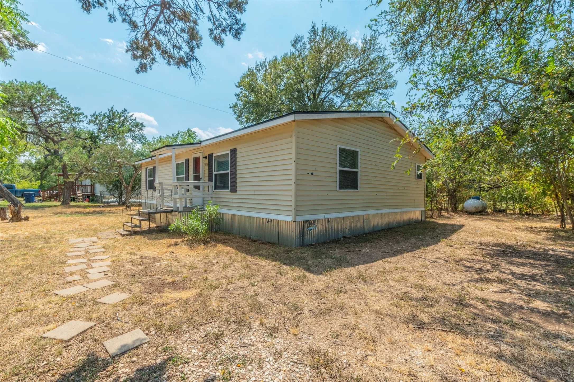 View of property exterior with a yard