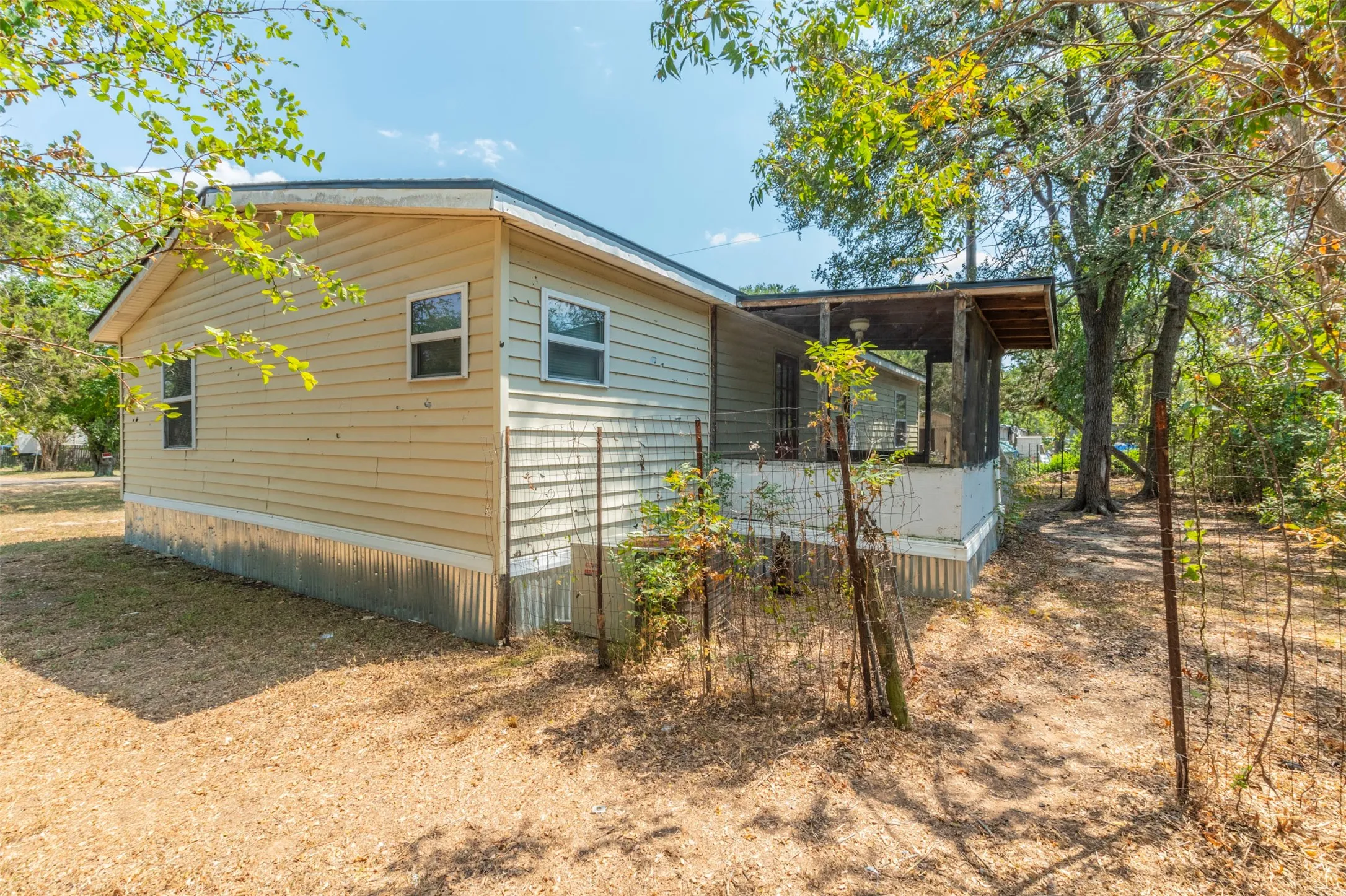 View of property exterior with a sunroom