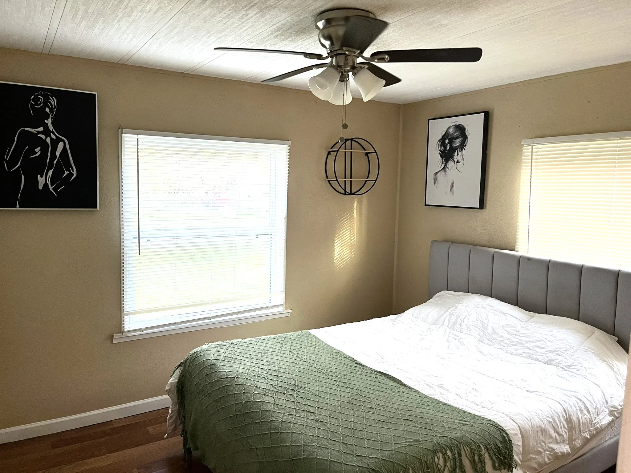 Bedroom with ceiling fan and dark wood-style flooring