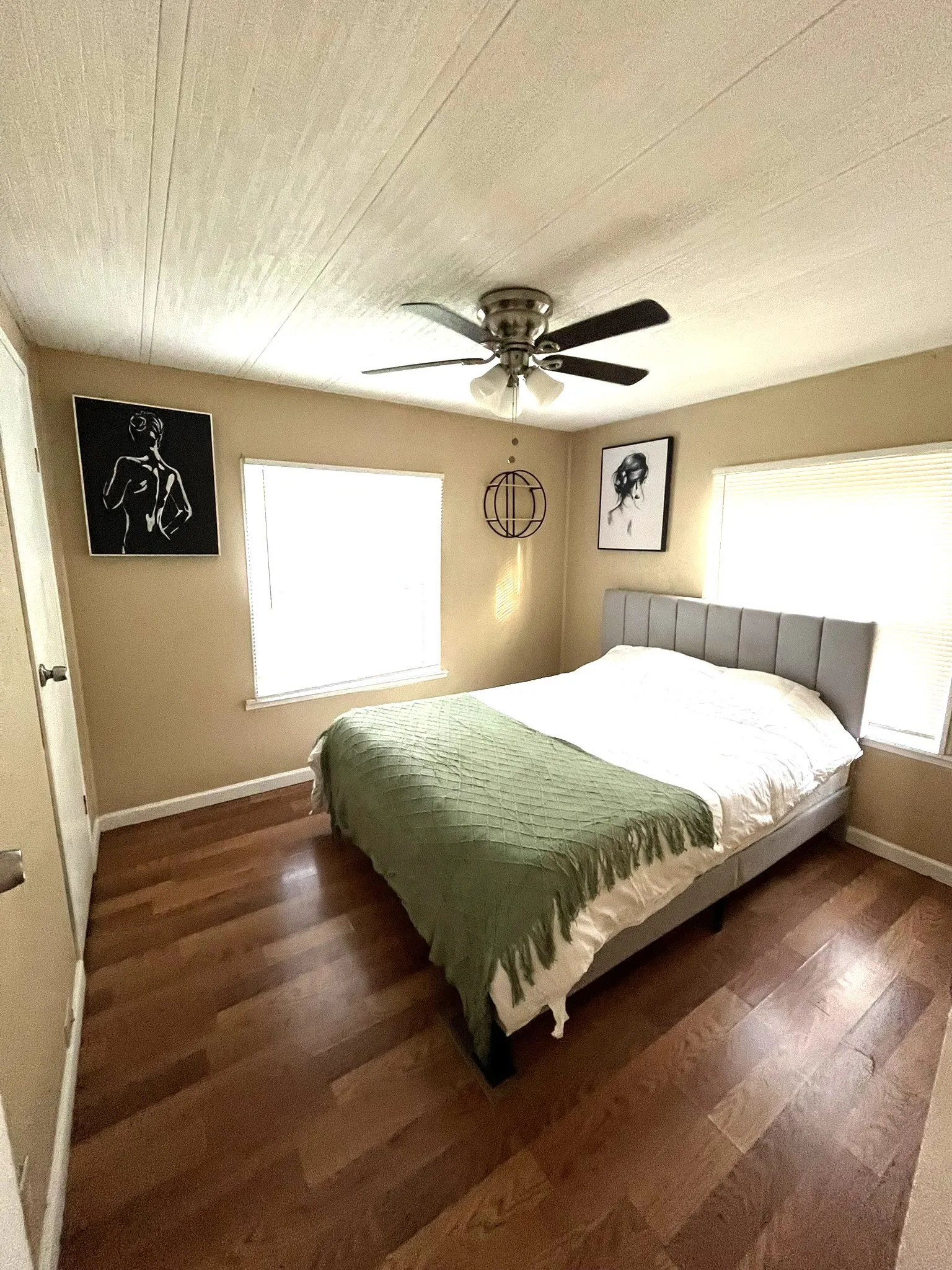 Bedroom featuring ceiling fan and dark wood-style flooring
