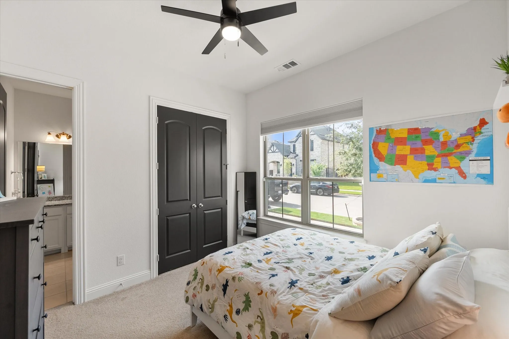 Bedroom with light carpet, a ceiling fan, and a closet