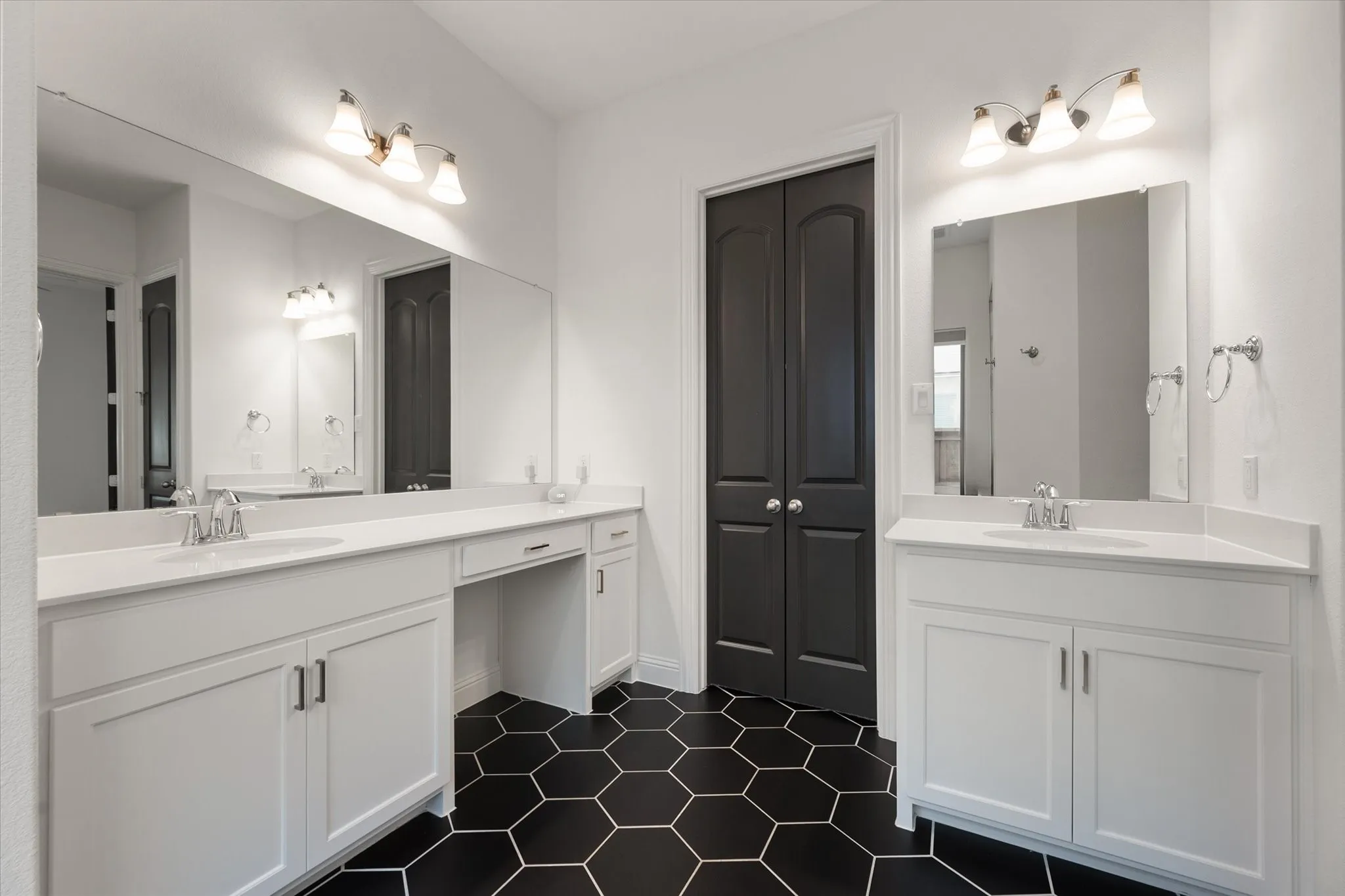 Full bath featuring two vanities and dark tile patterned flooring