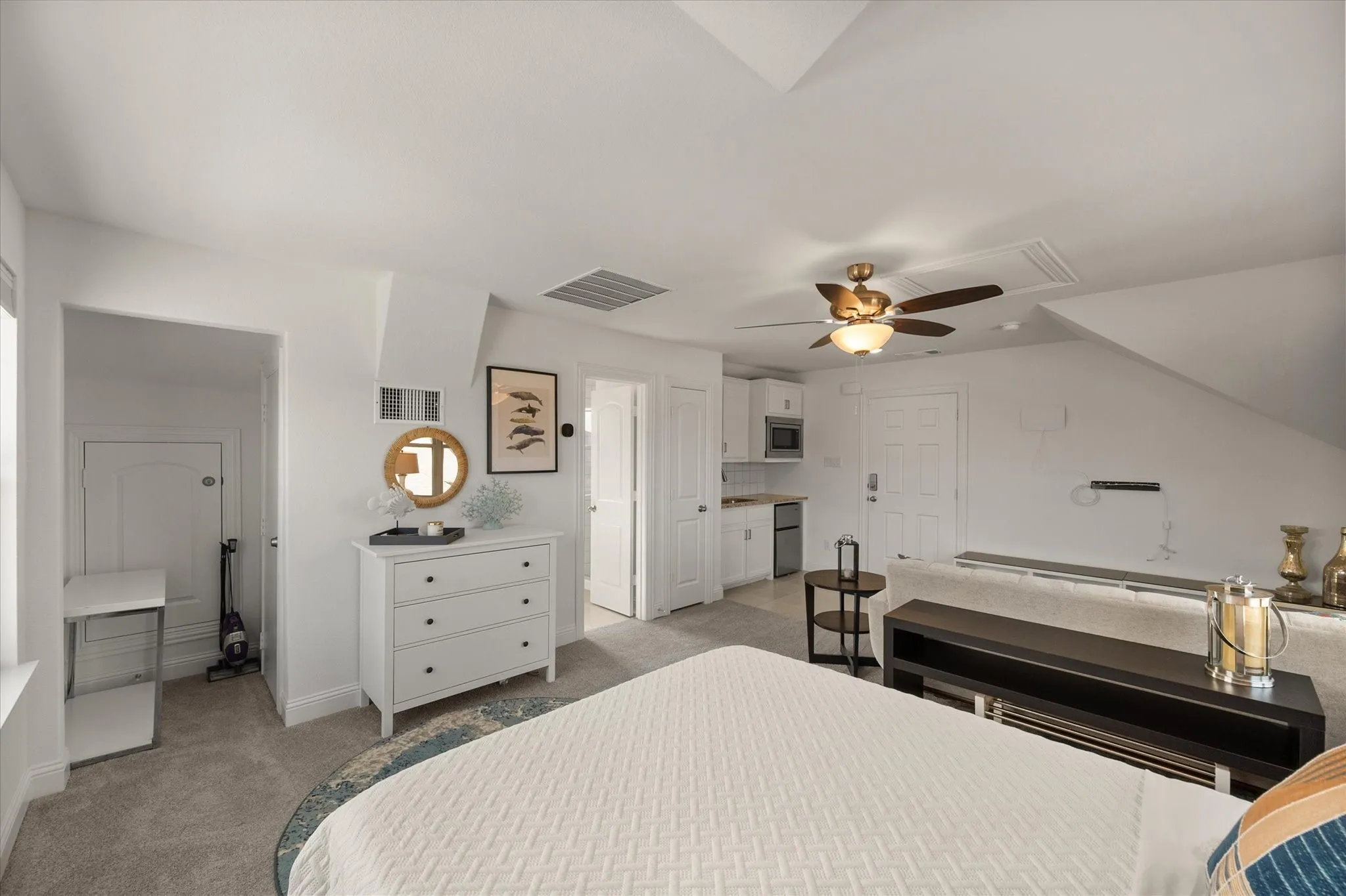 Bedroom featuring light colored carpet and ceiling fan
