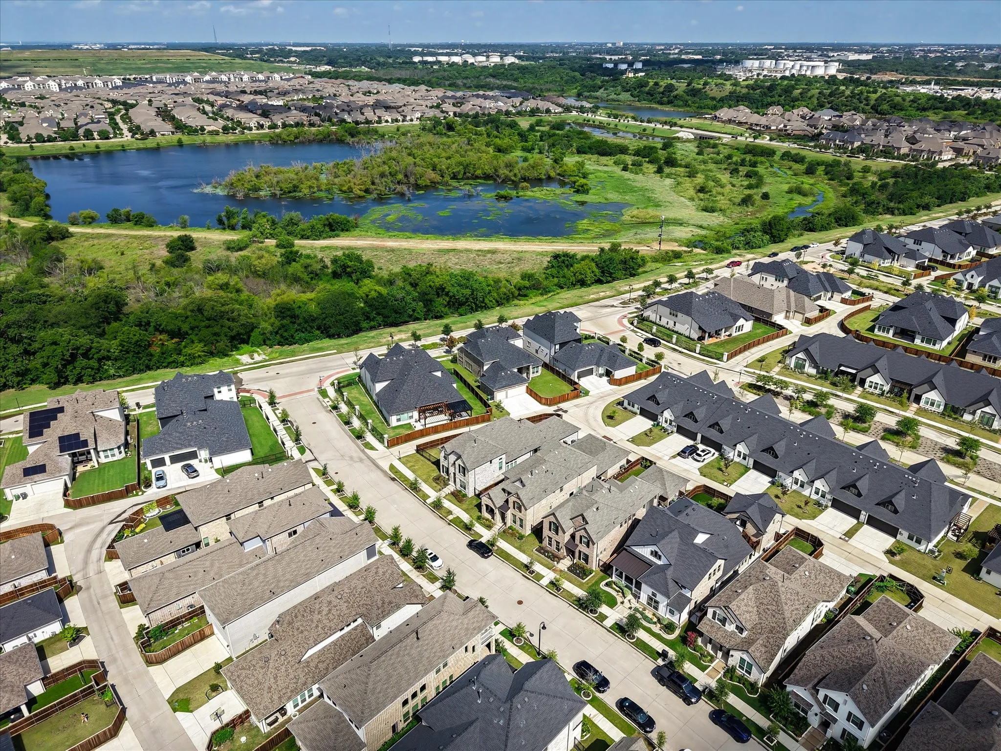Aerial overview of property's location featuring nearby suburban area and a nearby lakes