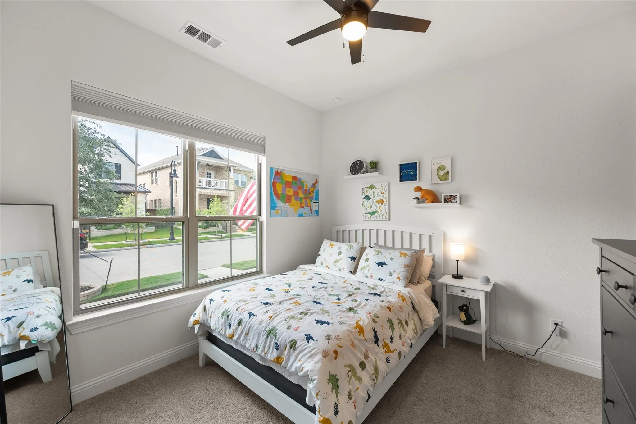Bedroom with light carpet and a ceiling fan
