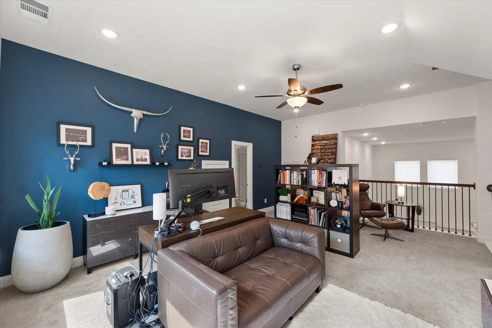 Carpeted upstairs  office space or gameroom featuring recessed lighting and ceiling fan