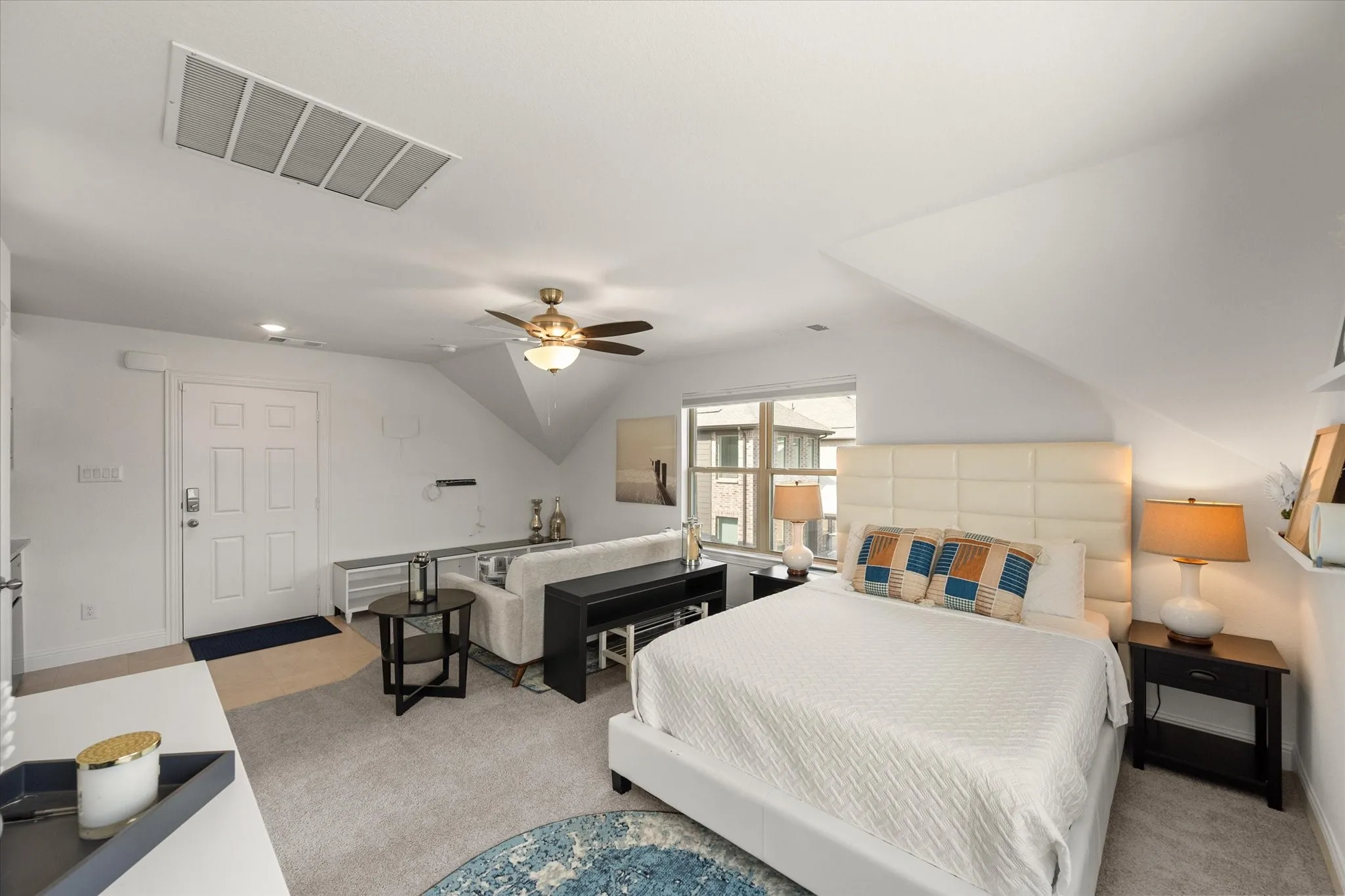 Upstairs Garage Studio Bedroom with light colored carpet and a ceiling fan