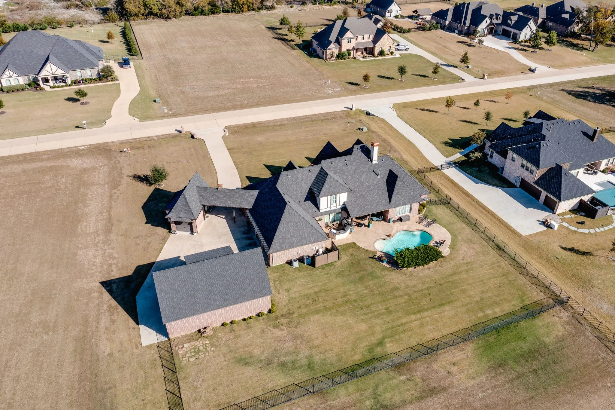 Aerial view of residential area featuring a pool