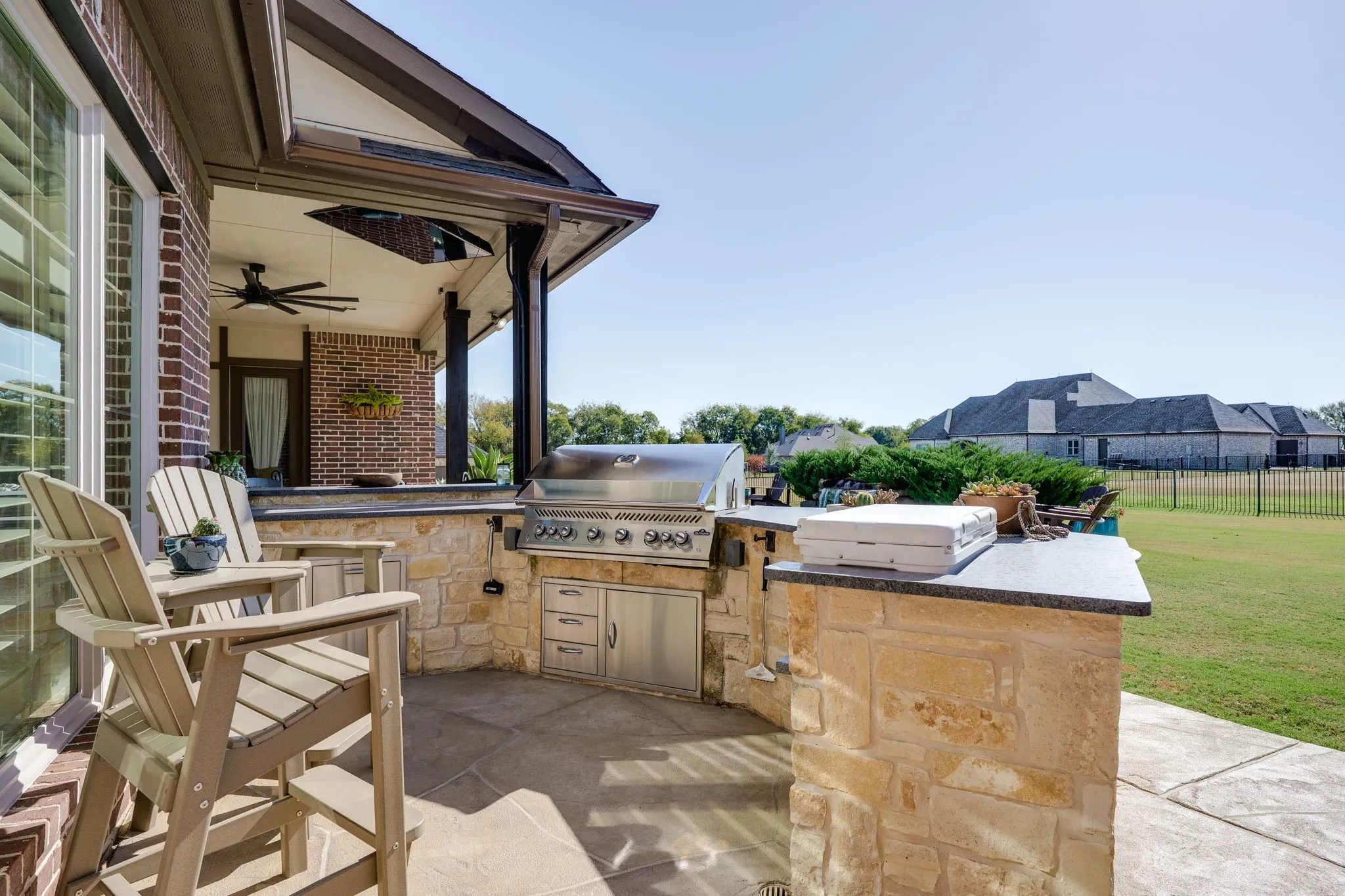 View of patio / terrace with ceiling fan and outdoor grilling area and island  sit and eat
