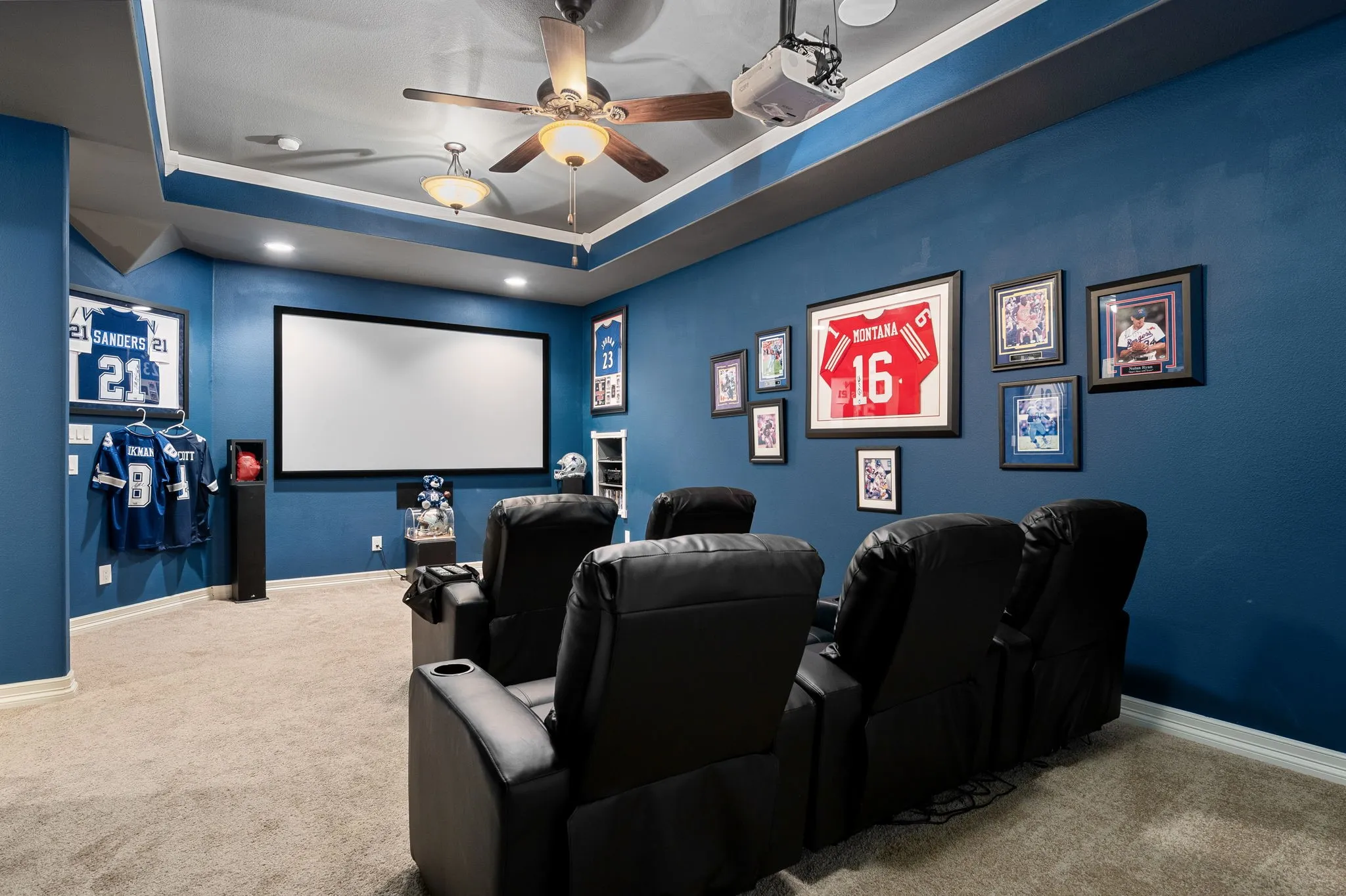 Cinema room featuring a raised ceiling, carpet, a ceiling fan, and recessed lighting