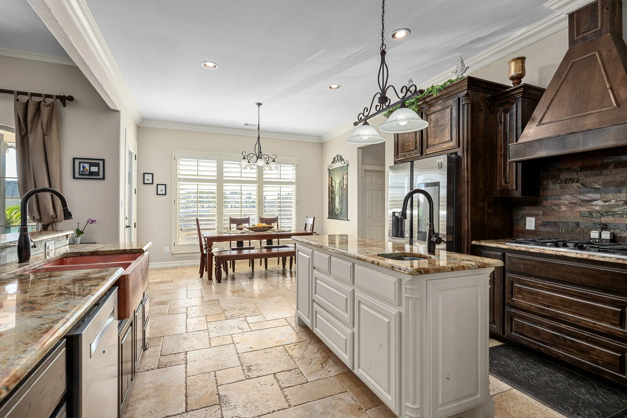Kitchen featuring lgranite counters, pendant lighting, cast iron sink