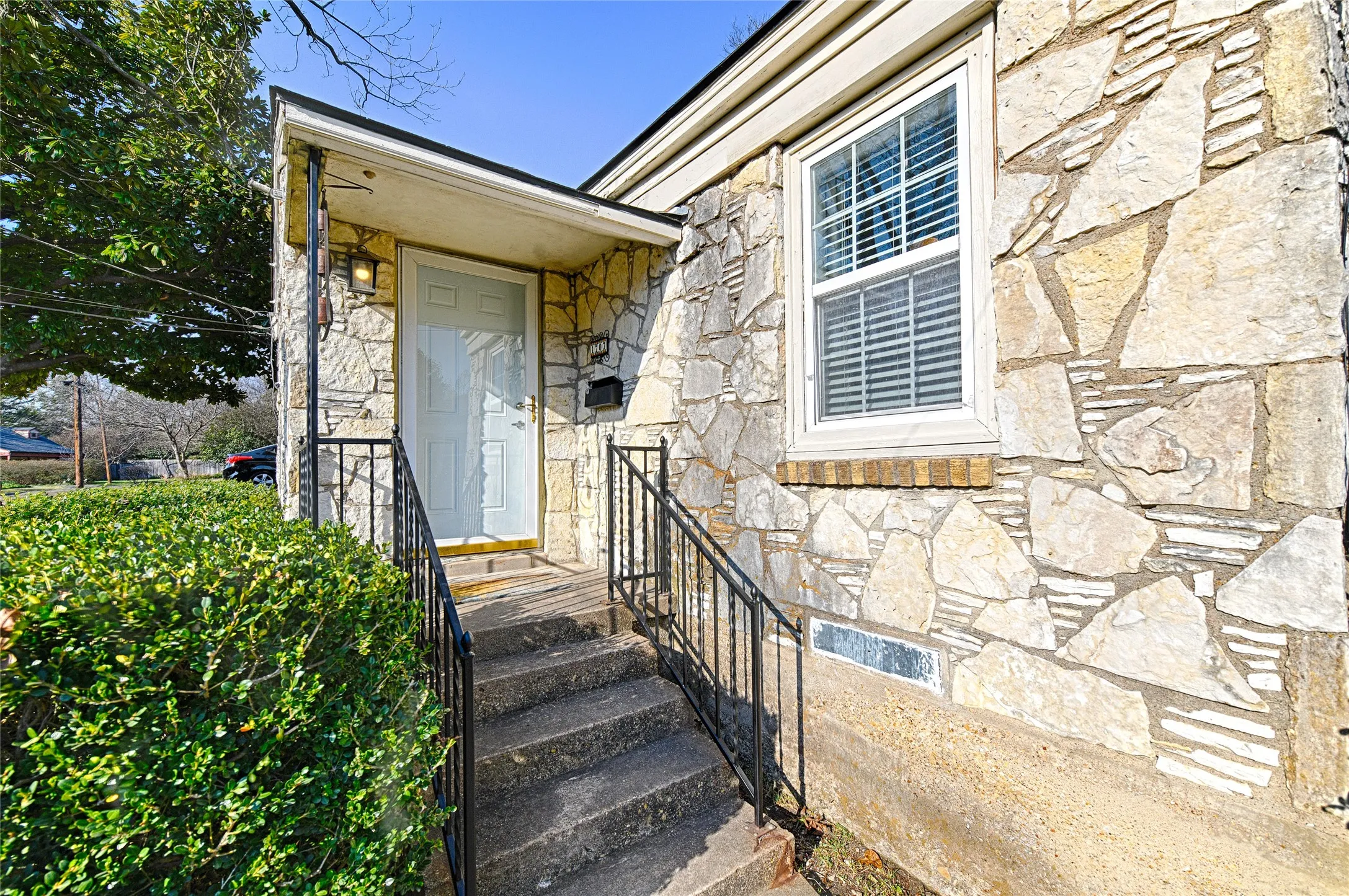 Property entrance featuring stone siding