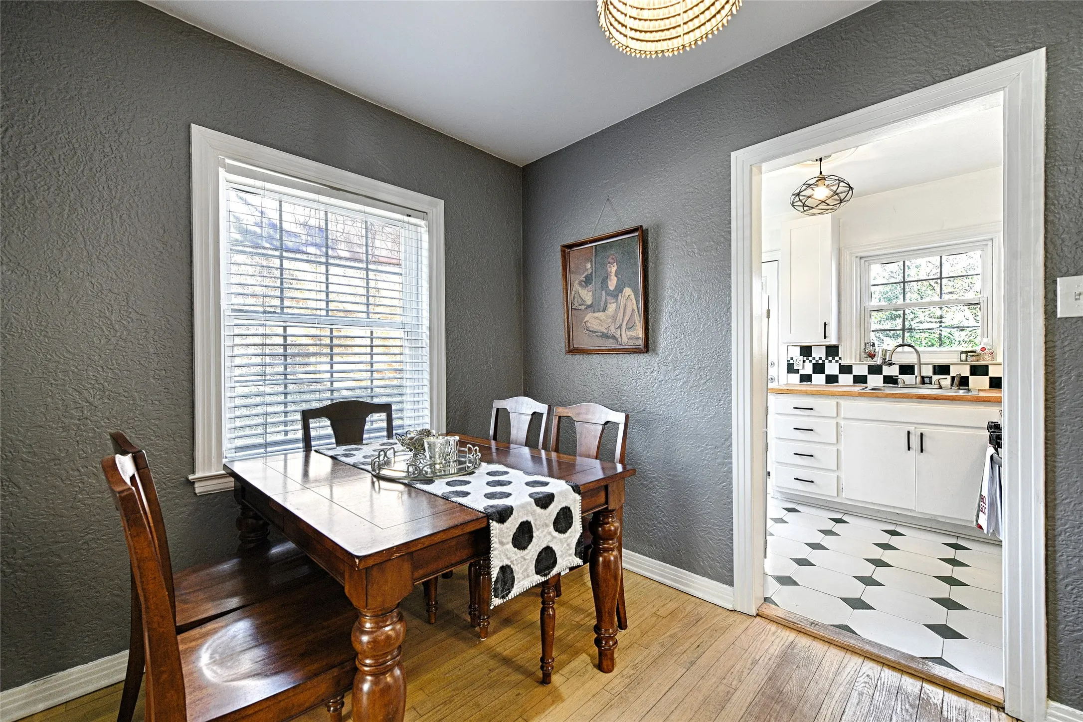 Dining room featuring a textured wall and light wood finished floors