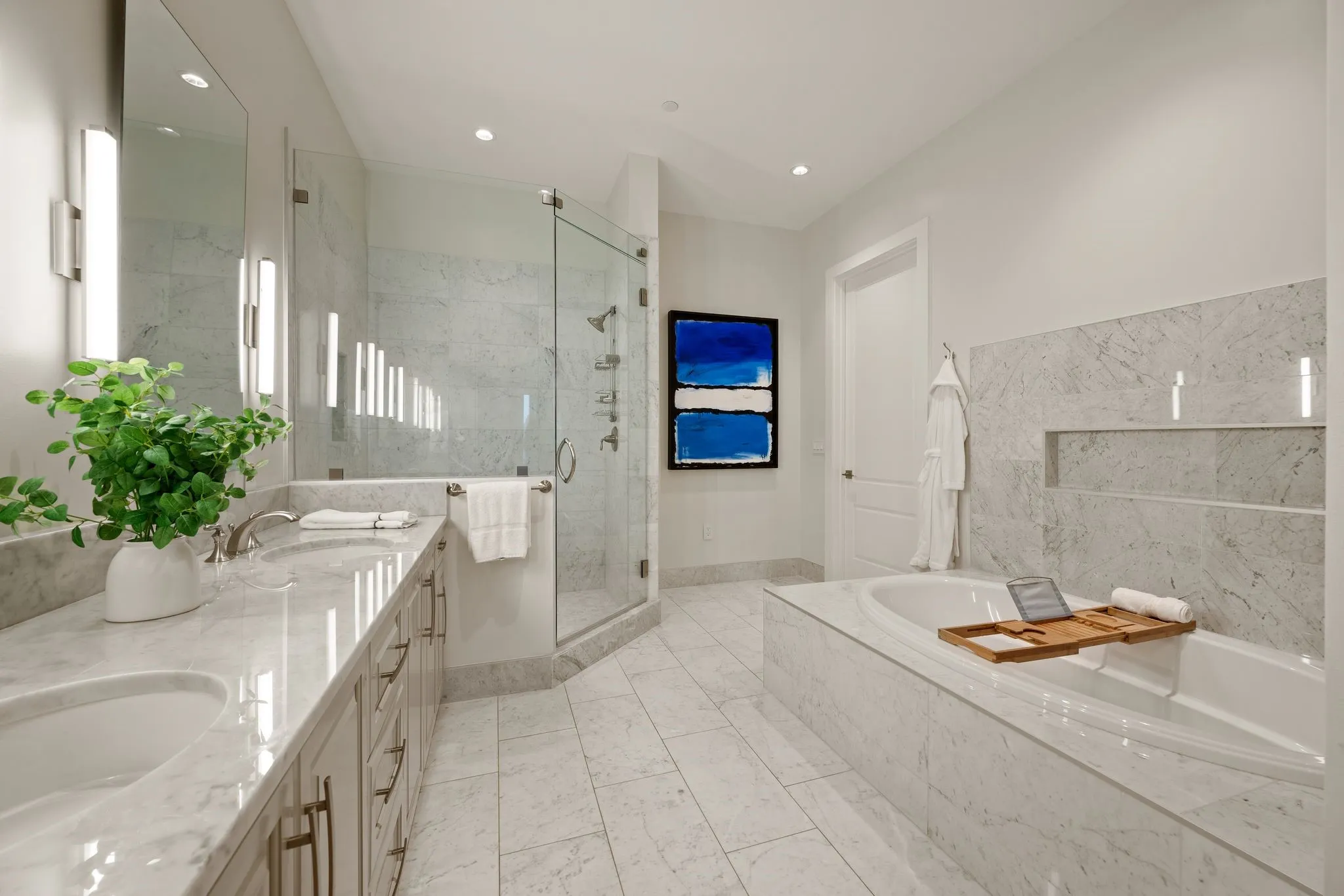 Full bath featuring a shower stall, double vanity, a bath, and a sink