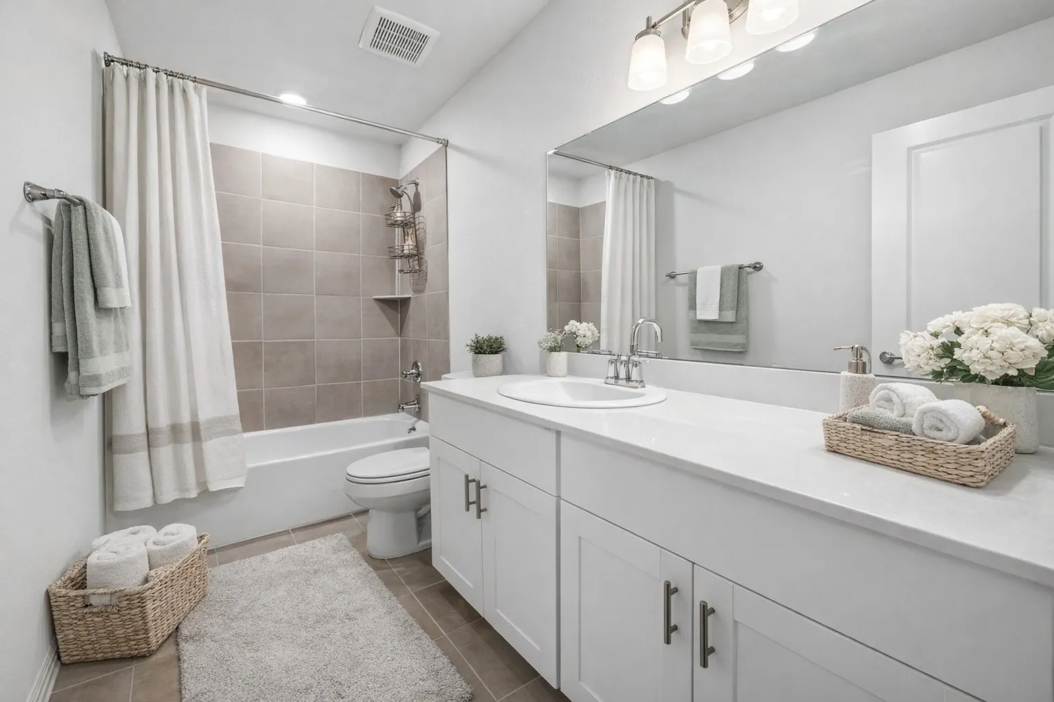Bathroom with vanity, shower / tub combo with curtain, and dark tile patterned flooring