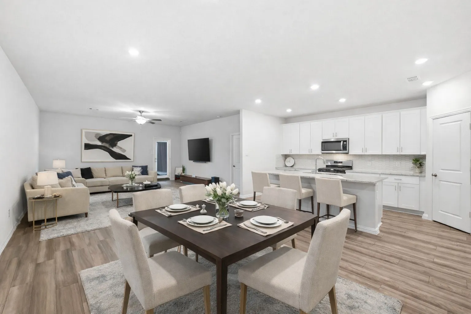 Dining room featuring light wood finished floors, ceiling fan, and recessed lighting