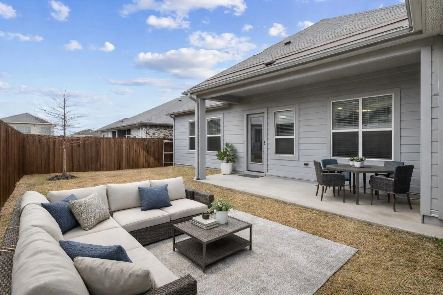 Fenced backyard with a patio area and an Virtual Staged
outdoor living / dining area