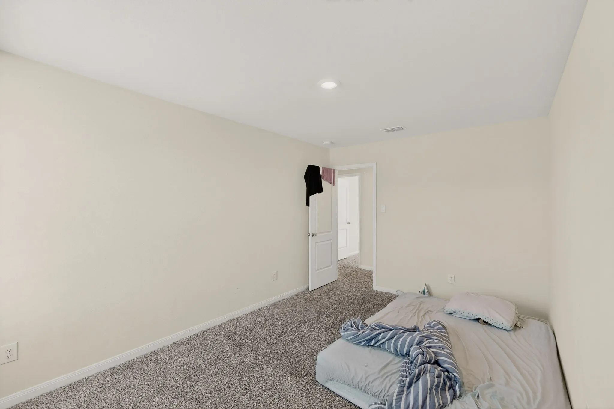 Unfurnished bedroom featuring carpet floors and baseboards