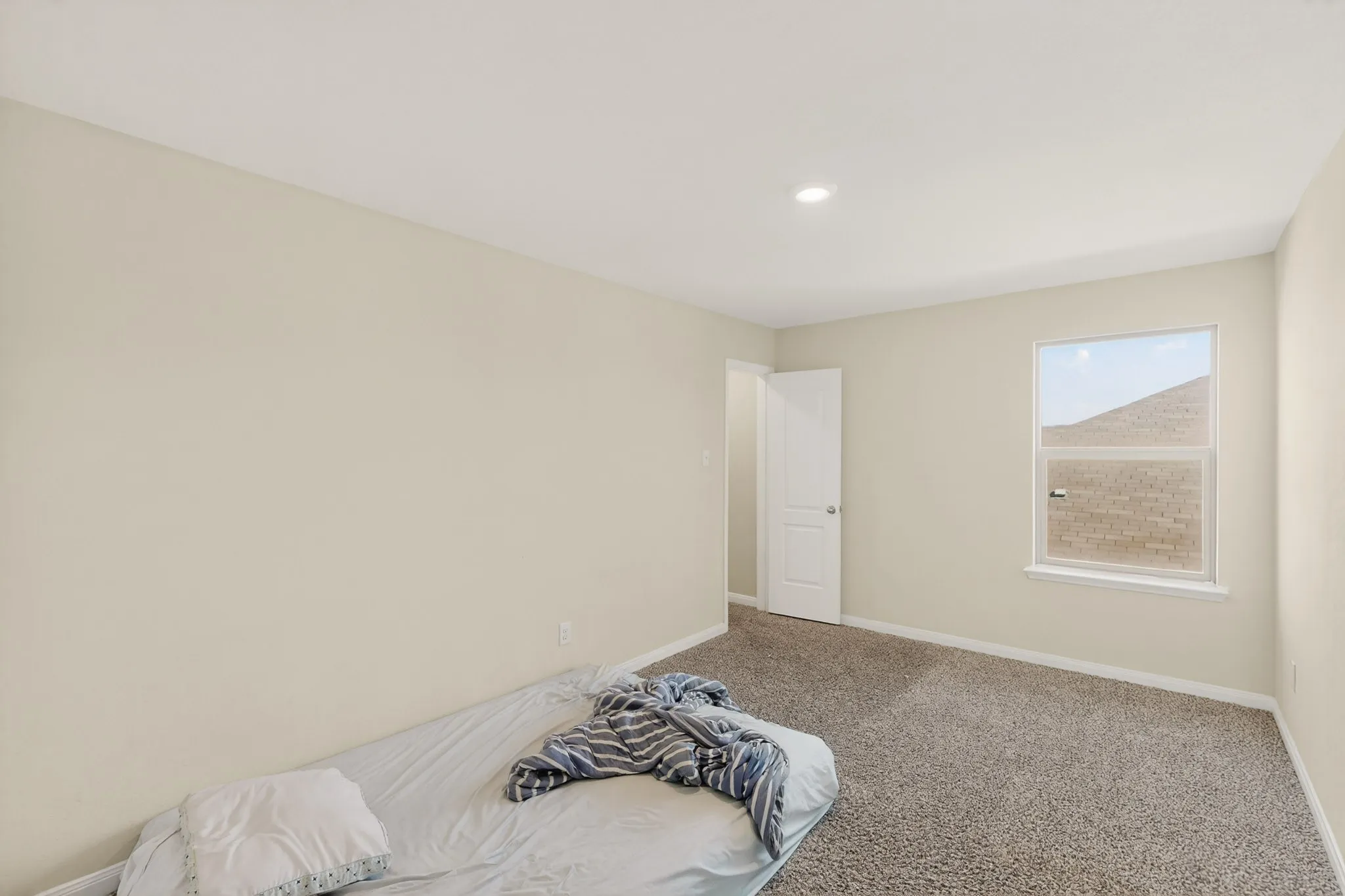 Unfurnished bedroom featuring baseboards and carpet flooring