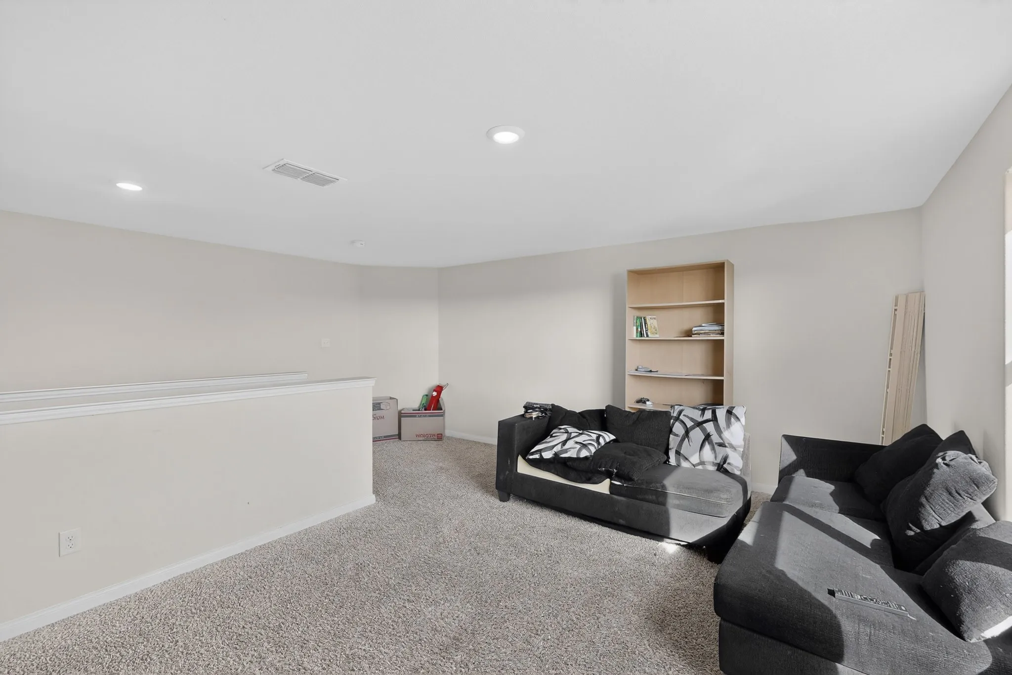 Living area with carpet and recessed lighting