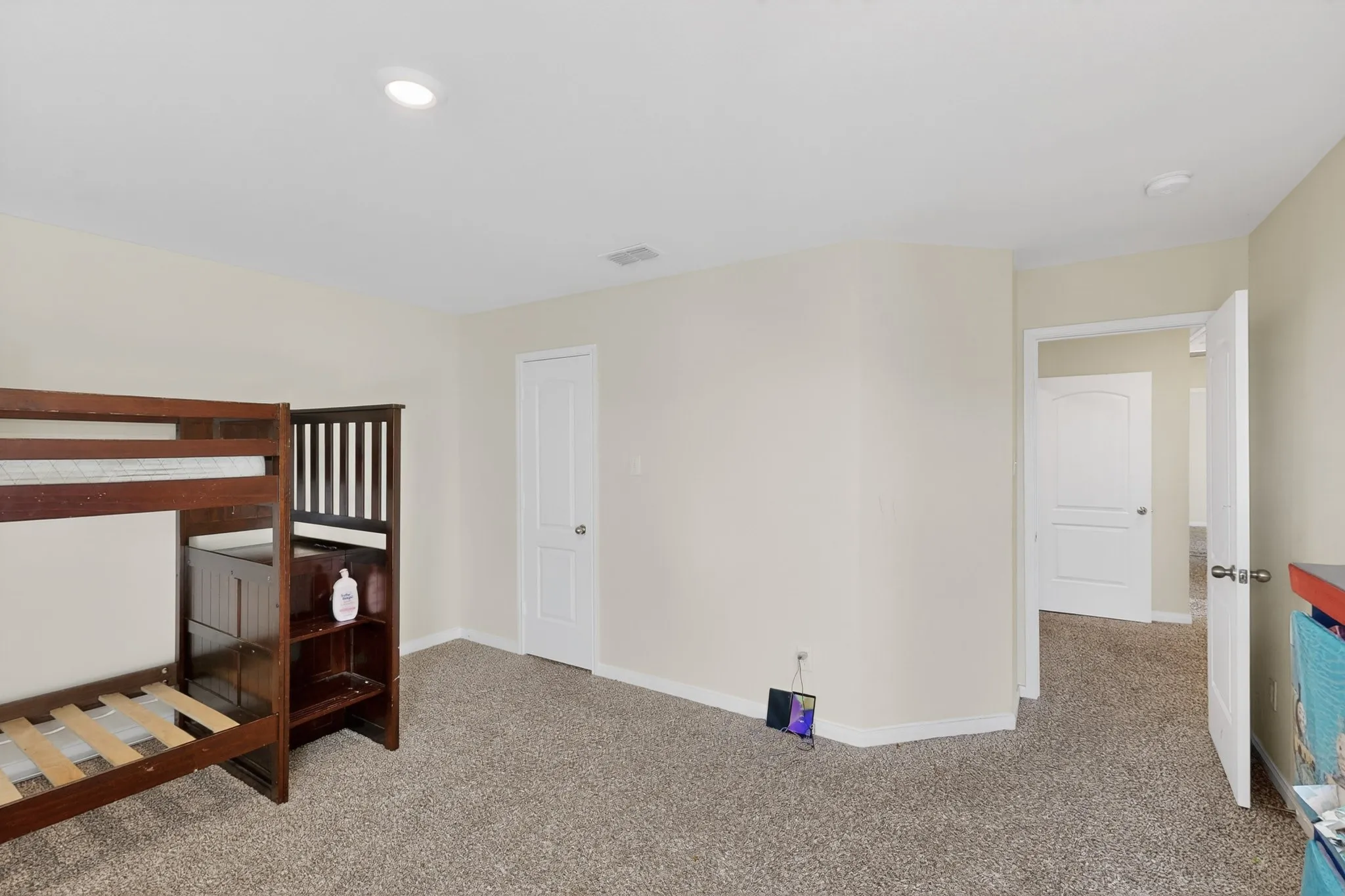 Bedroom featuring carpet and baseboards