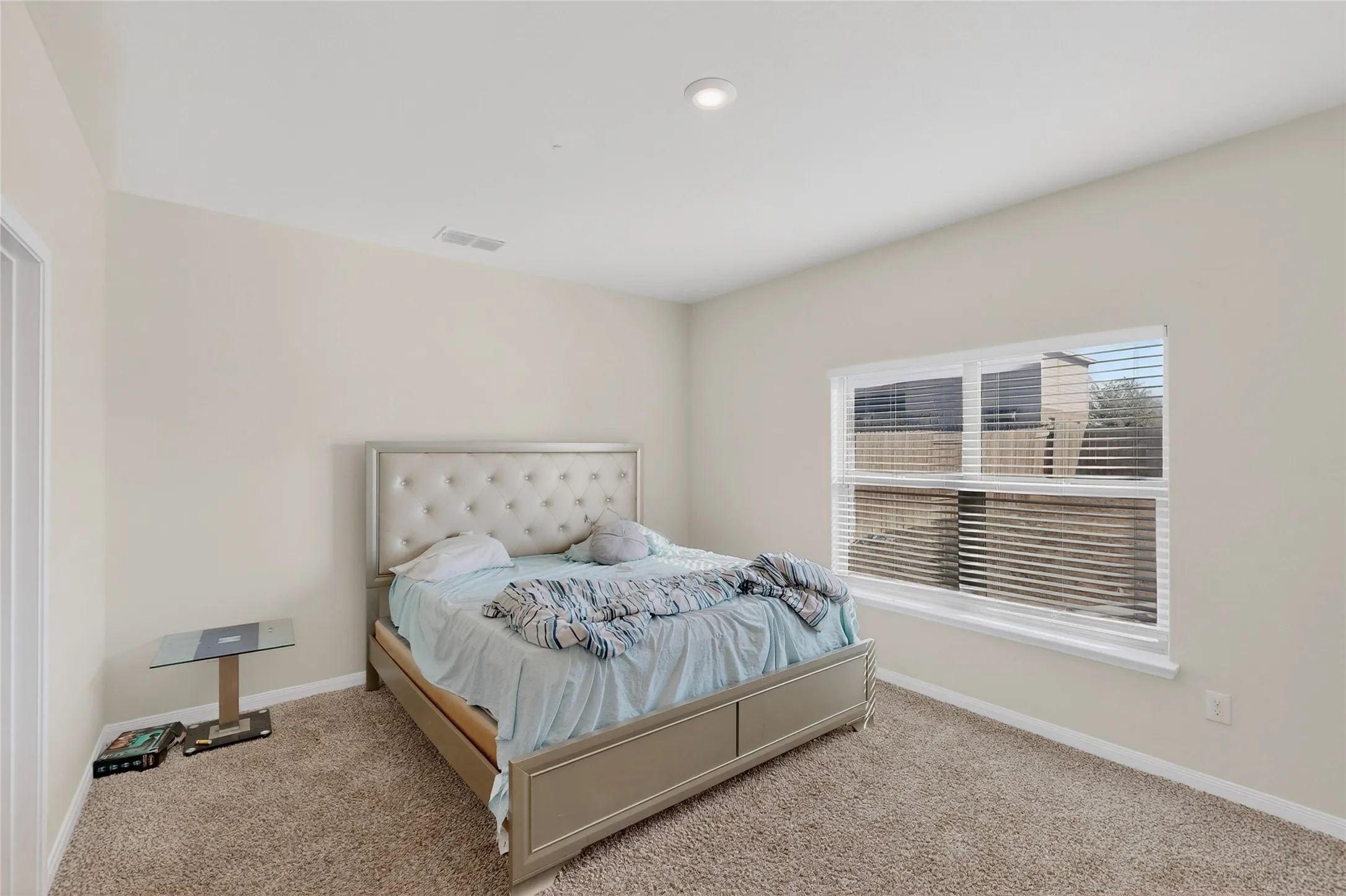Bedroom featuring baseboards and carpet